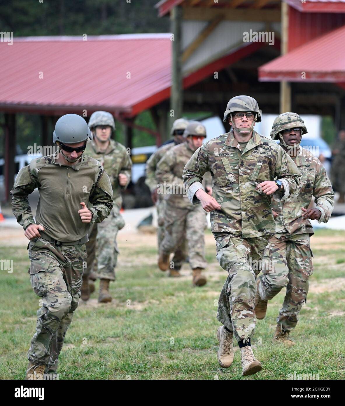 Soldiers from Support Battalion, 1st Special Warfare Training Group (Airborne) run in a race during the battalion's Commander's Cup competition at Fort Bragg, North Carolina April 15, 2021. The Soldiers from each company competed in a ruck march, obstacle course, land navigation, Jeopardy-themed trivia contest and stress shoot with pistols and rifles. Stock Photo