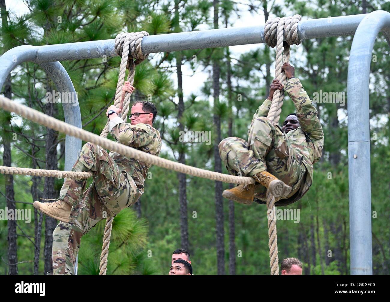 Soldiers from Support Battalion, 1st Special Warfare Training Group (Airborne) negotiate an obstacle during the battalion's Commander's Cup competition at Fort Bragg, North Carolina April 15, 2021. The Soldiers from each company competed in a ruck march, obstacle course, land navigation, Jeopardy-themed trivia contest and stress shoot with pistols and rifles. Stock Photo