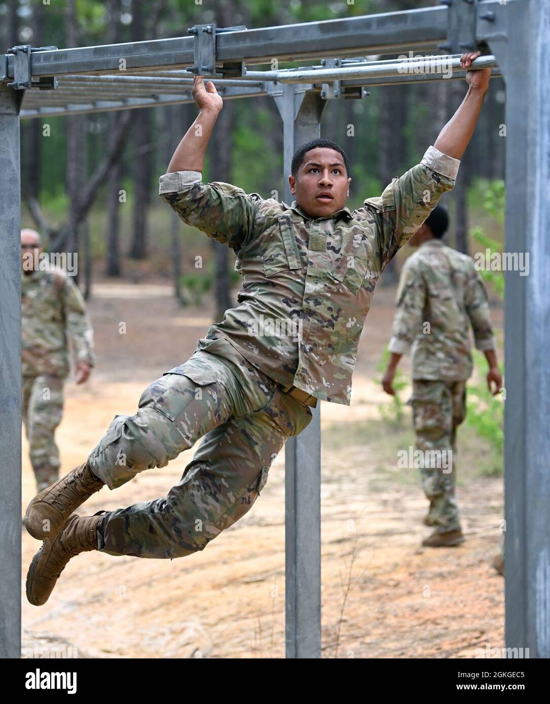A Soldier from Support Battalion, 1st Special Warfare Training Group (Airborne) negotiates an obstacle during the battalion's Commander's Cup competition at Fort Bragg, North Carolina April 15, 2021. The Soldiers from each company competed in a ruck march, obstacle course, land navigation, Jeopardy-themed trivia contest and stress shoot with pistols and rifles. Stock Photo