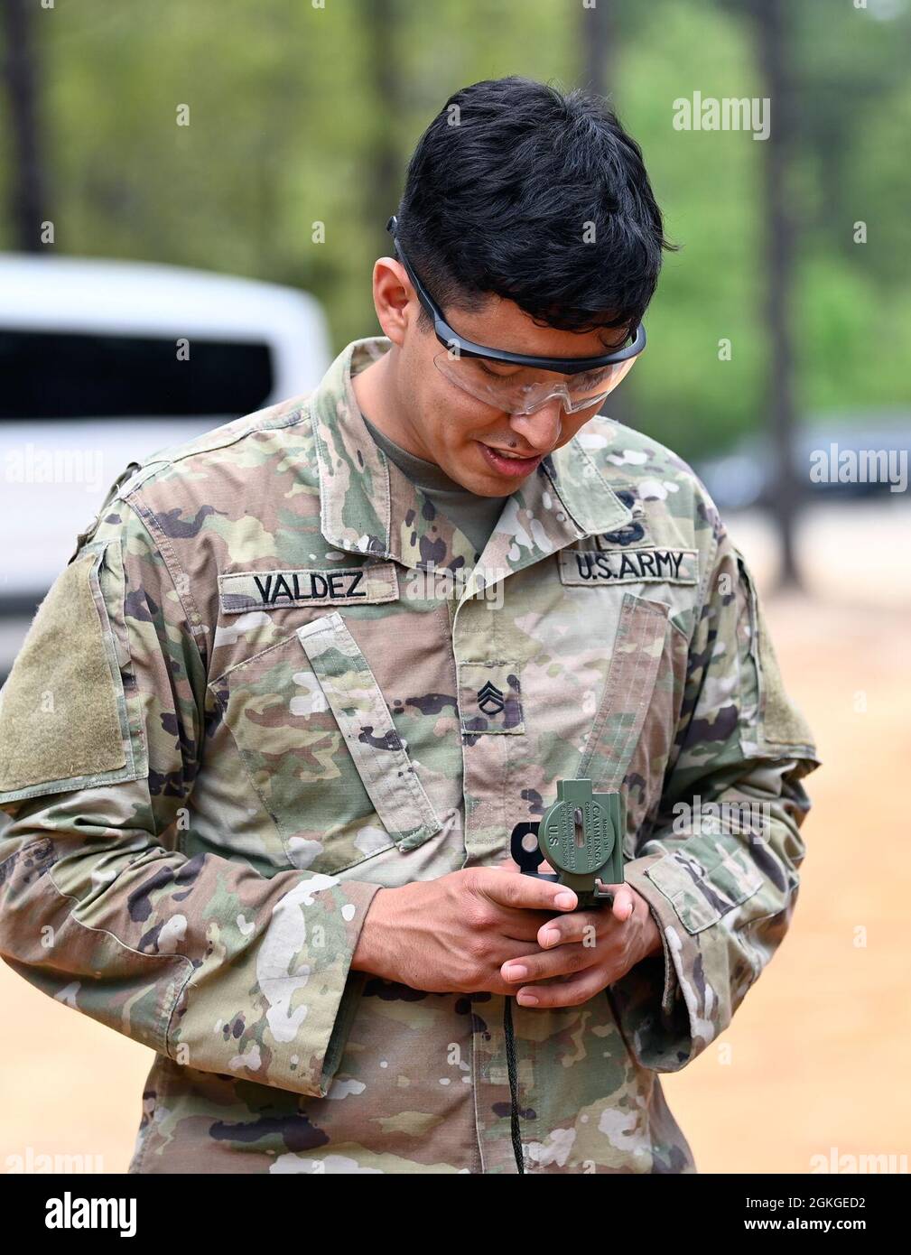 A Soldier from Support Battalion, 1st Special Warfare Training Group (Airborne) shoots an azimuth during the battalion's Commander's Cup competition at Fort Bragg, North Carolina April 15, 2021. The Soldiers from each company competed in a ruck march, obstacle course, land navigation, Jeopardy-themed trivia contest and stress shoot with pistols and rifles. Stock Photo