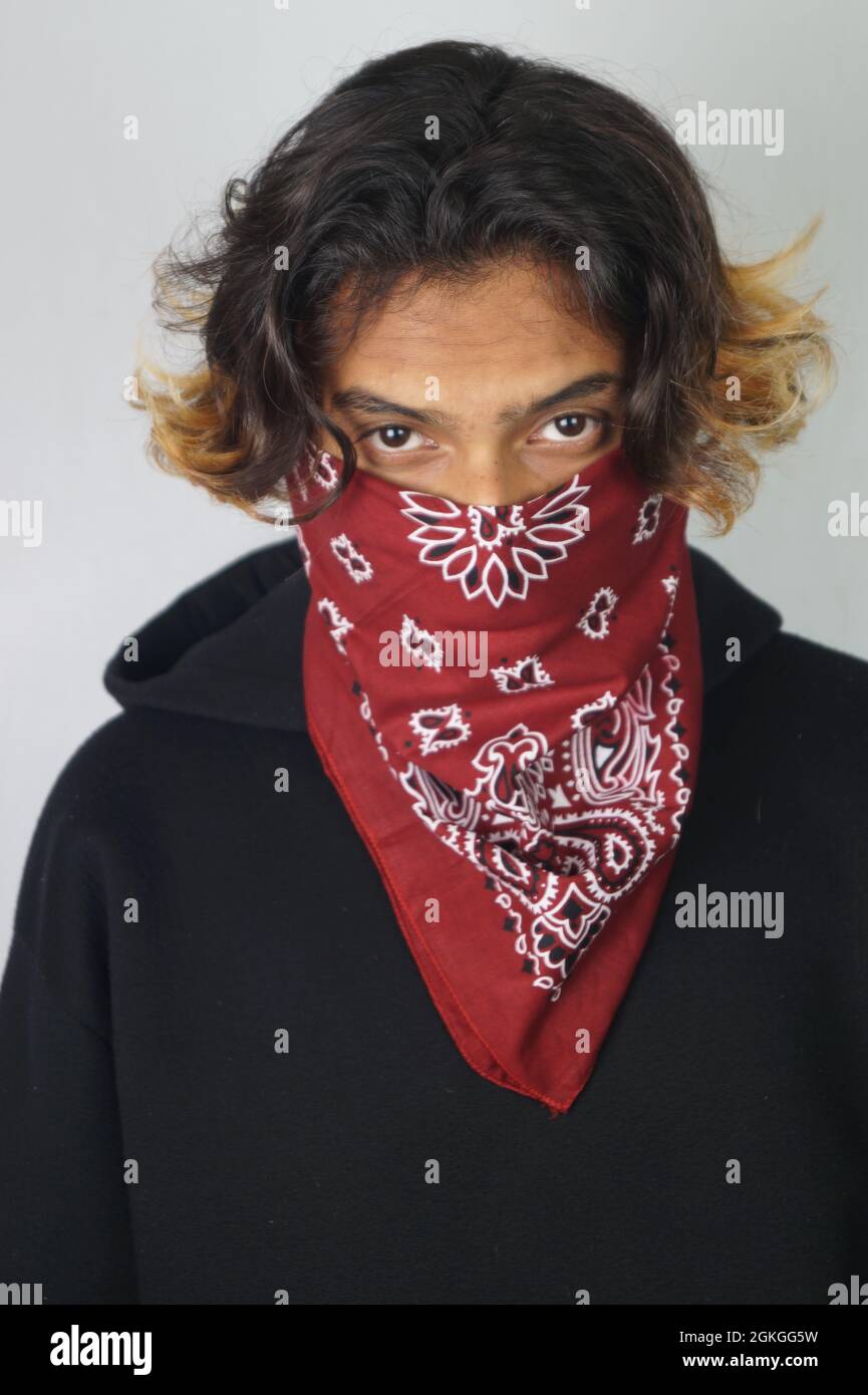 Young thug Indian male with a bandana covering his face Stock Photo Alamy