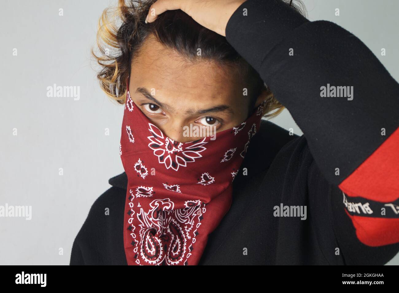 Young thug Indian male with a bandana covering his face Stock Photo Alamy
