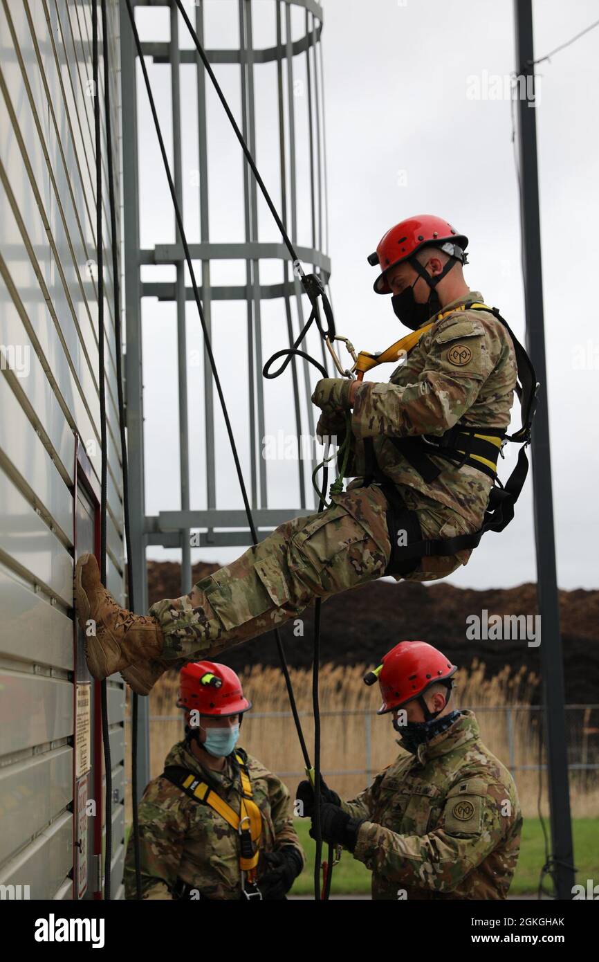 Staff Sgt. Joshua Kaczmarek of the New York Army National Guard's Bravo Company, 152nd Brigade Engineer Battalion practices ascending a building by rope during a Homeland Response Force collective training extercise in East Amherst, New York on April 16. Kaczmarek is assigned to the search and extraction element of the FEMA Region II Homeland Response Force. Stock Photo