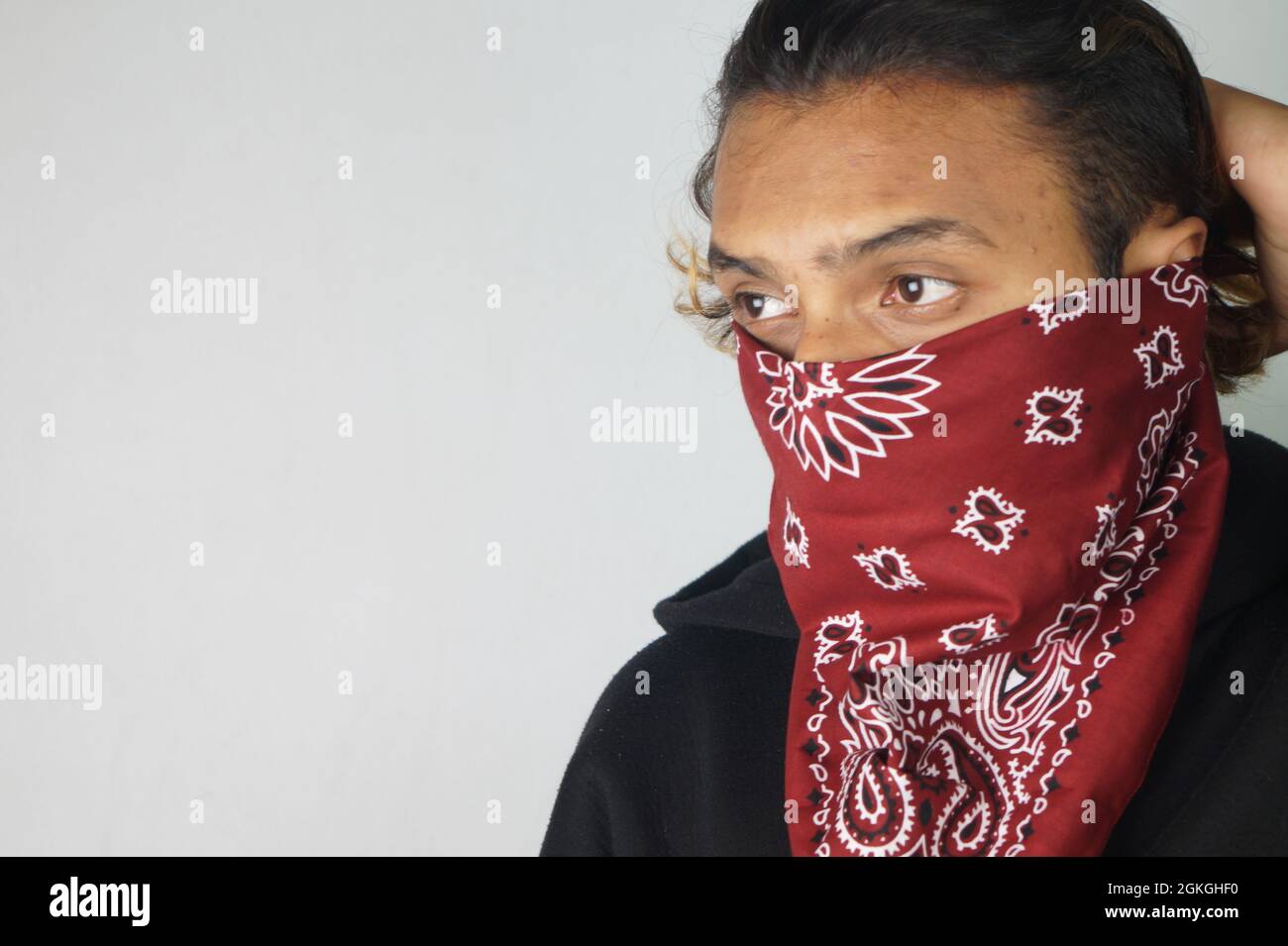 Young thug Indian male with a bandana covering his face Stock Photo - Alamy