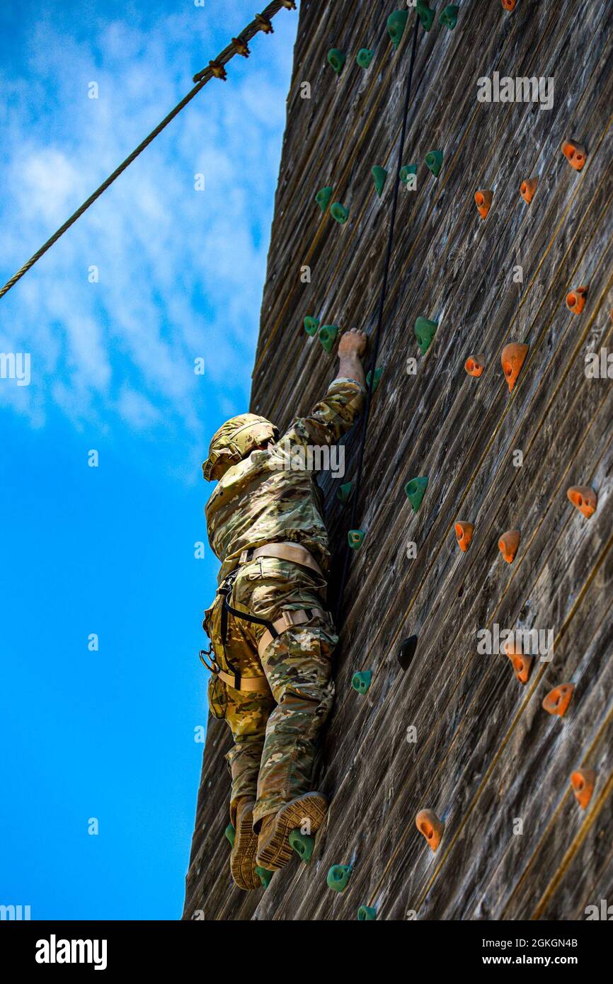 1st. Lt. Harrison Rooney, 1st Battalion, 27th Infantry Regiment, 2nd Infantry Regiment Brigade Combat Team, 25th Infantry Division,  scales the rock-climbing wall on the Tri-Wall course as part of the Day Stakes event at the 2021 Best Ranger Competition in Fort Benning, GA, April 17, 2021. The Best Ranger Competition is a series of physical events such as swimming, rucking, and obstacle courses, that best showcase the competence, physical and mental endurance, and competitive spirit of the United States Army Ranger. Stock Photo