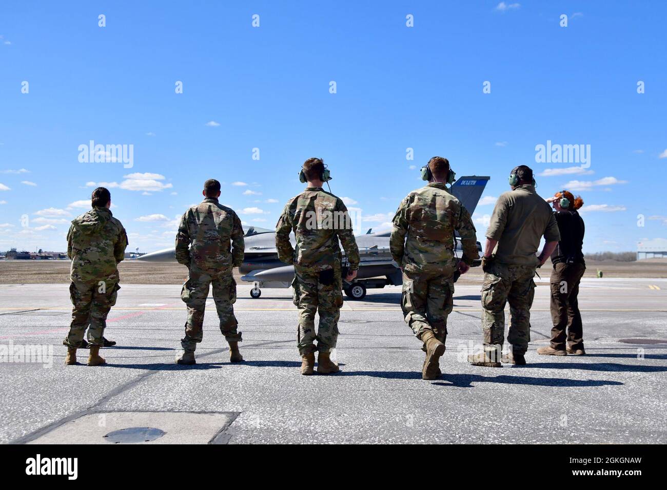 148th Fighter Wing Crew Chiefs watch an F-16 Fighting Falcon taxi from an End of Runway (EOR) inspection to the runway at the Duluth, Minn. Air National Guard Base April 17, 2021. EOR provides a final inspection of the aircraft prior to take off. Stock Photo