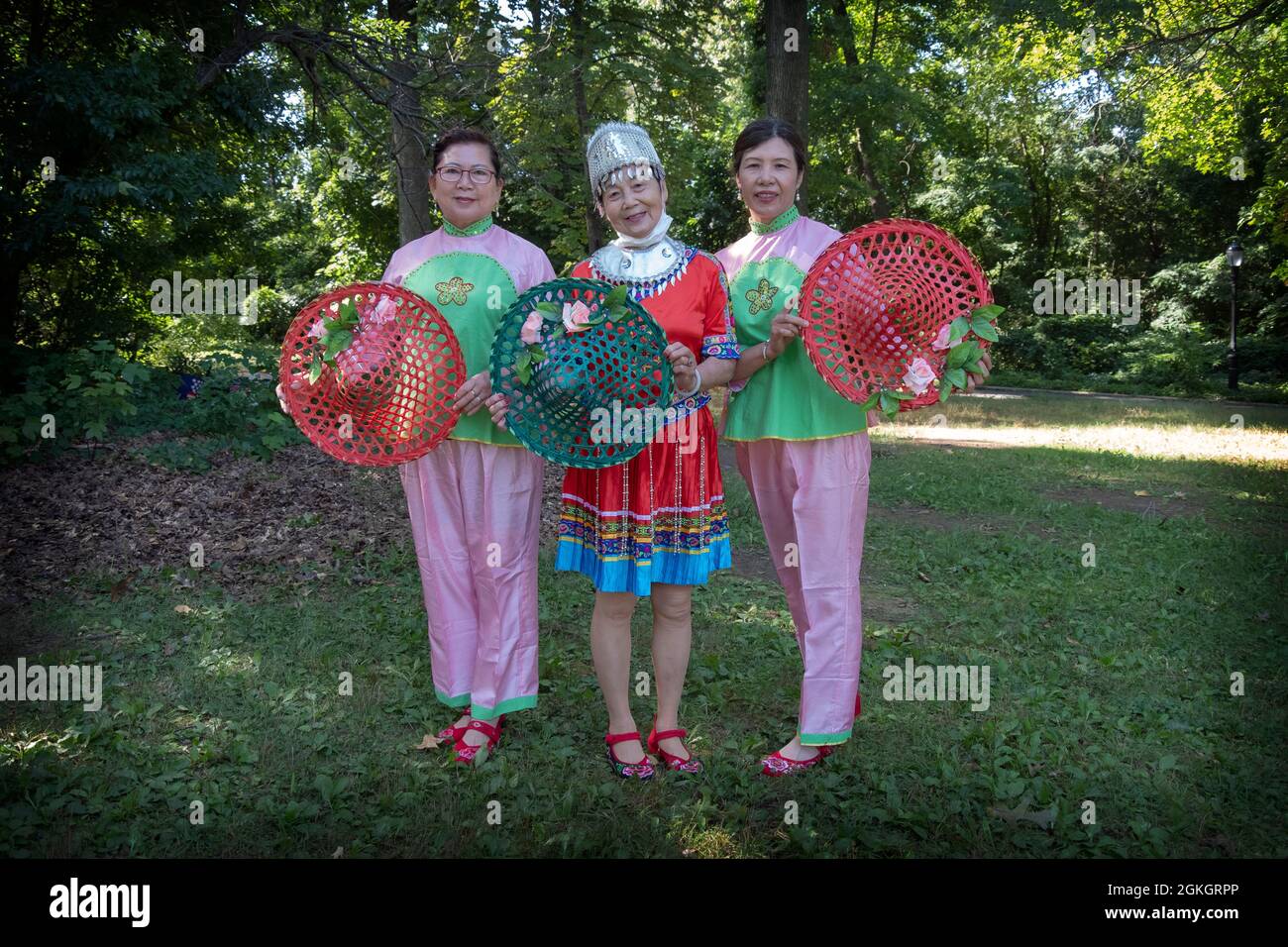 Posed portrait of three women in the Kai Xin Yizhu dance troupe. Prior to a performance in a park in Flushing, Queens, New york City Stock Photo