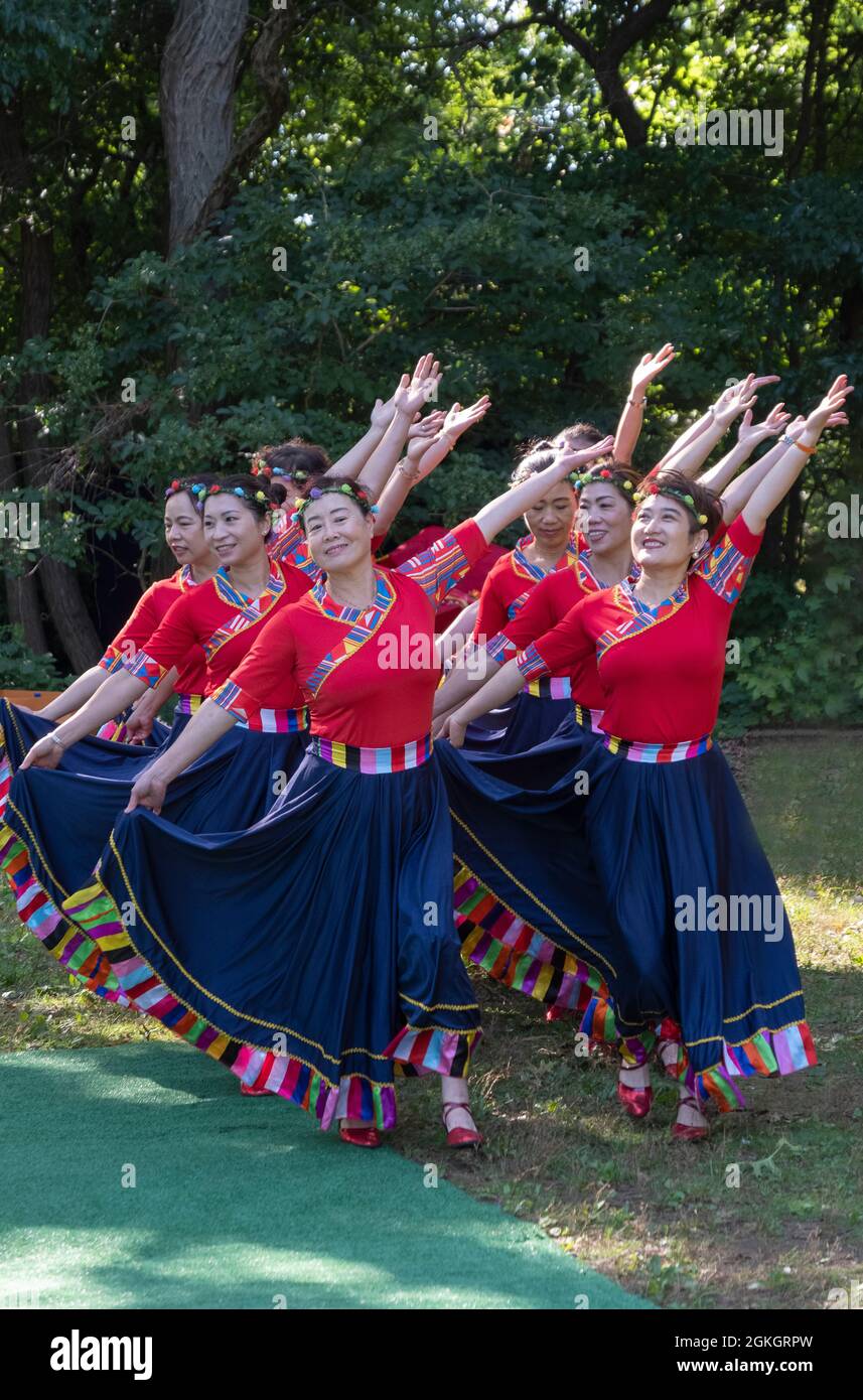 Women from Wenzhou, China in the Kai Xin Yizhu dance troupe celebrate their 6th anniversary with a performance in a Kissena Park in Queens, New York. Stock Photo