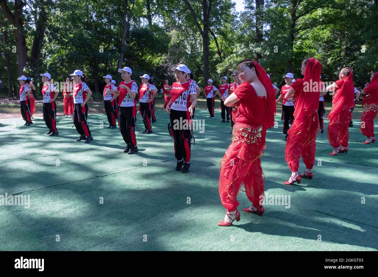 Women from Wenzhou, China in the Kai Xin Yizhu dance troupe celebrate their 6th anniversary with a performance in a Kissena Park in Queens, New York. Stock Photo