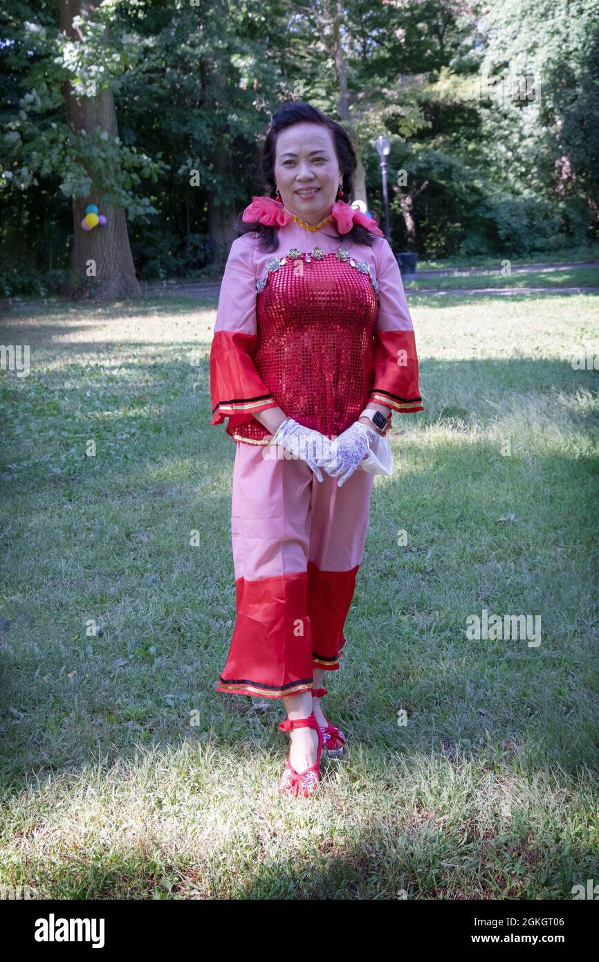 Posed portrait of a woman in the Kai Xin Yizhu dance troupe. Prior to a performance in a park in Flushing, Queens, New york City Stock Photo