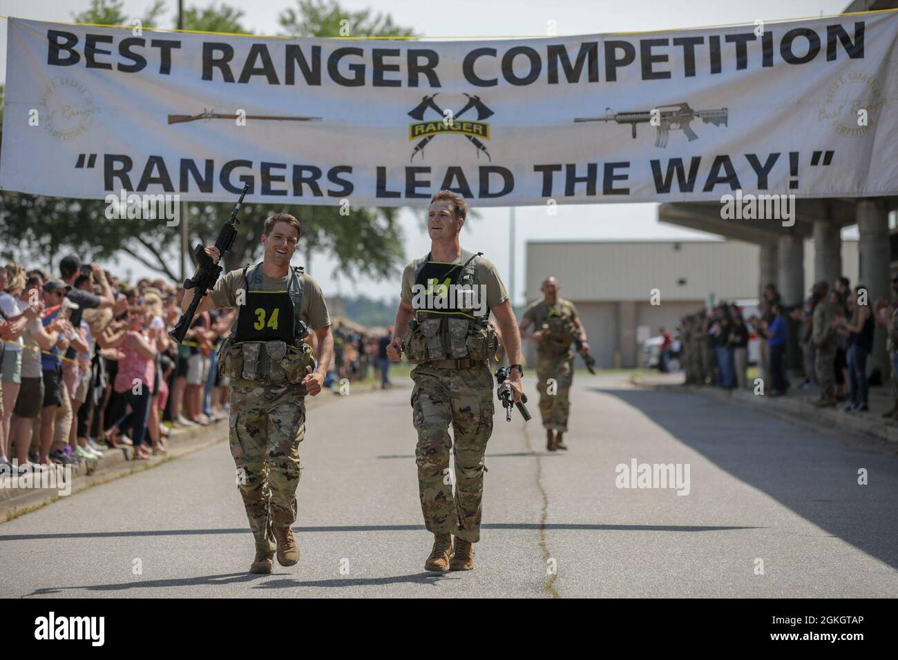 U.S. Army 1st. Paikowski and 1st Lt. Alastair Keys, assigned to the 75th Regiment, cross the finish line of the final buddy run at Freedom Hall, Fort Benning, Ga.,