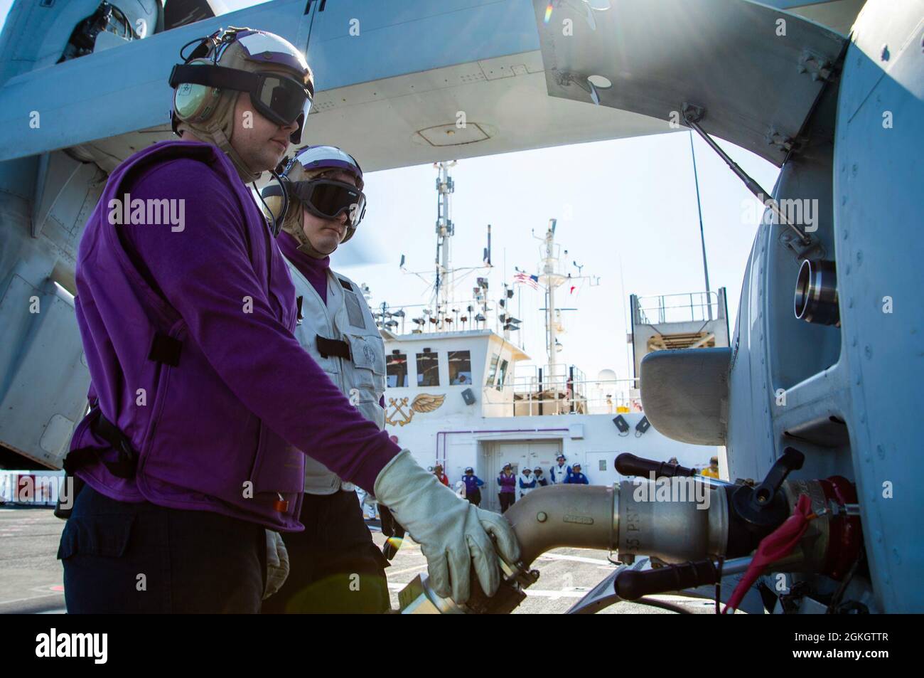 210418-N-LW757-1343  PACIFIC OCEAN (Apr. 18, 2021) Aviation Boatswain’s Mate (Fuels) 3rd Class Shane Tulles (left) and Hospitalman Noah Miannan (right), both Sailors assigned to Military Sealift Command hospital ship USNS Mercy (T-AH 19), refuel an MV-22B Osprey assigned to Air Test and Evaluation (HX) Squadron 21 of Naval Air Station (NAS) Patuxent River, Md., on the ship’s flight deck Apr. 18. Mercy is underway off the coast of Southern California completing Dynamic Interface Testing, where the ship’s aviation facilities will be evaluated for compatibility with the V-22 Osprey and MH-60 Seah Stock Photo