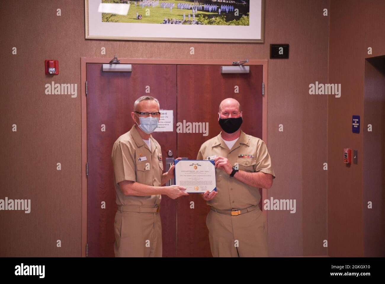 WASHINGTON (April 19, 2021) Capt. Ken Collins, commanding officer of the U.S. Navy Band, recognizes Senior Chief Musician Patrick White, from Williamsport, Maryland, on the occasion of his retirement after 27 years of service to the organization. Stock Photo