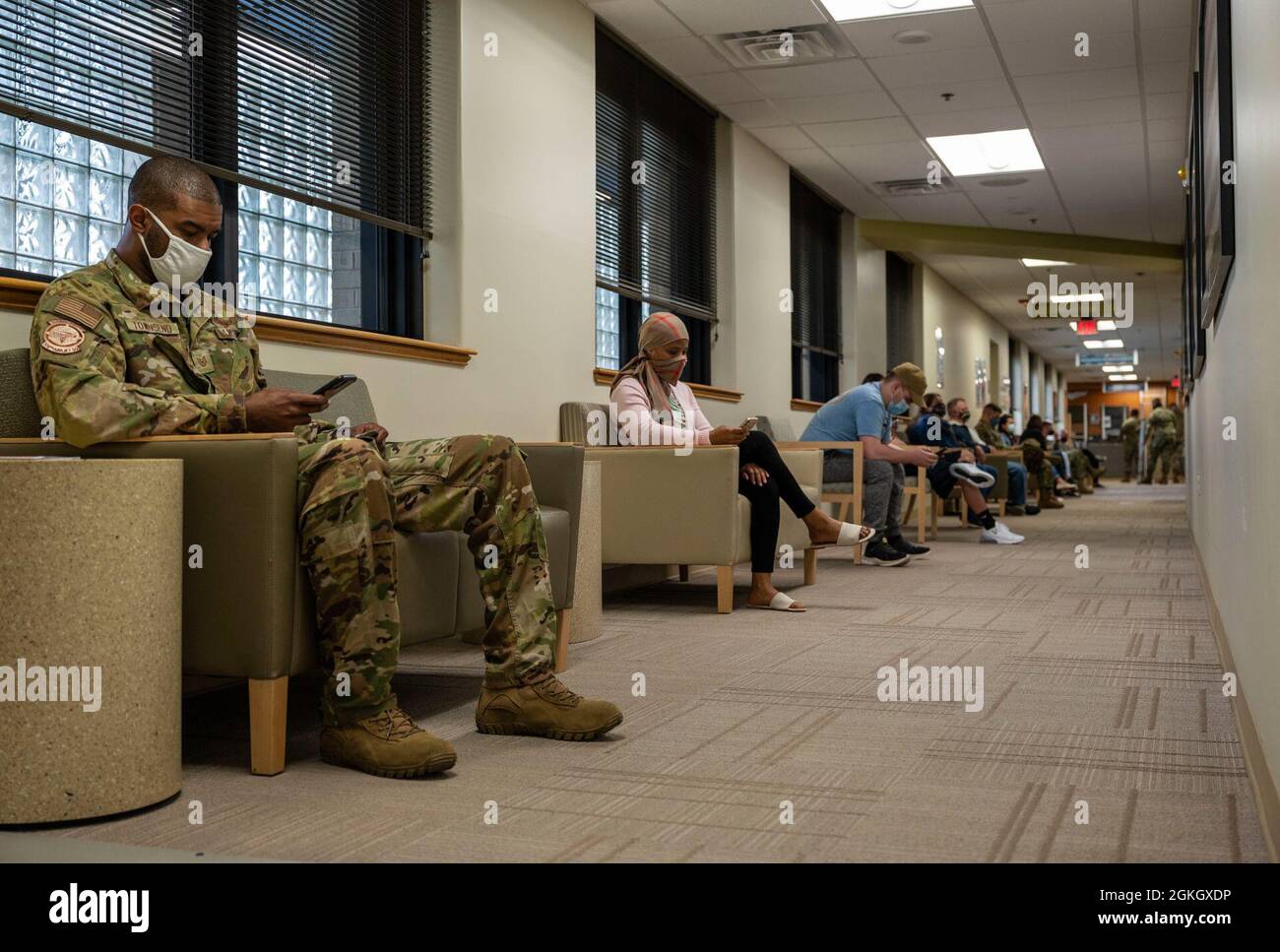 Patients wait in line to receive their first COVID-19 vaccine dose at Dover Air Force Base, Delaware, April 19, 2021. The 436th Medical Group opened vaccination eligibility to Tier 2 patients, which includes all healthy uniformed personnel and TRICARE beneficiaries. Stock Photo