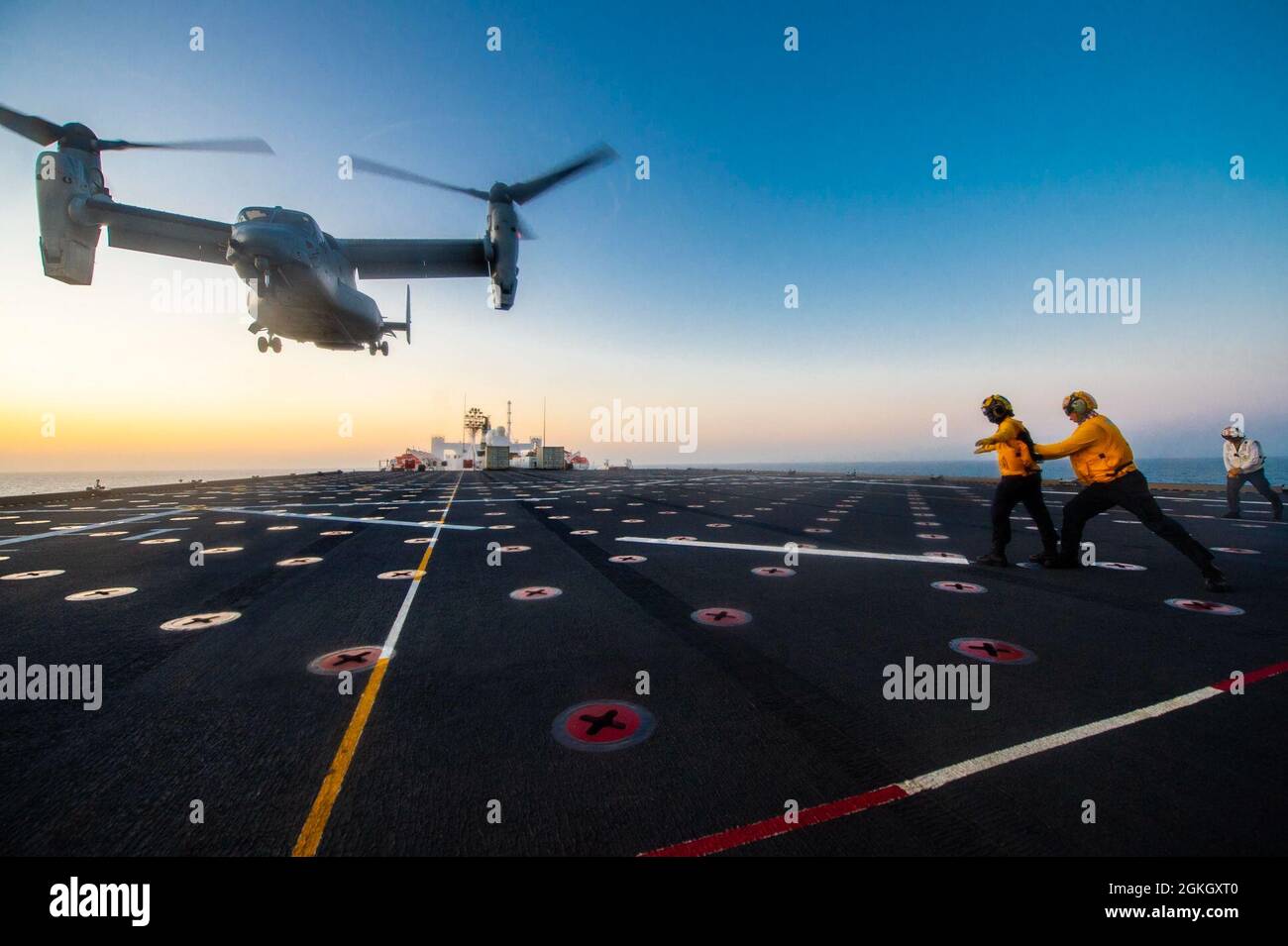 210419-N-LW757-1015  PACIFIC OCEAN (Apr. 19, 2021) Sailors assigned to the embarked Medical Treatment Facility’s Air Department aboard Military Sealift Command hospital ship USNS Mercy (T-AH 19) marshal an MV-22B Osprey assigned to Air Test and Evaluation (HX) Squadron 21 of Naval Air Station (NAS) Patuxent River, Md., on the ship’s flight deck Apr. 19. Mercy is underway off the coast of Southern California completing Dynamic Interface Testing, where the ship’s aviation facilities will be evaluated for compatibility with the V-22 Osprey and MH-60 Seahawk, and establish launch and recovery wind Stock Photo