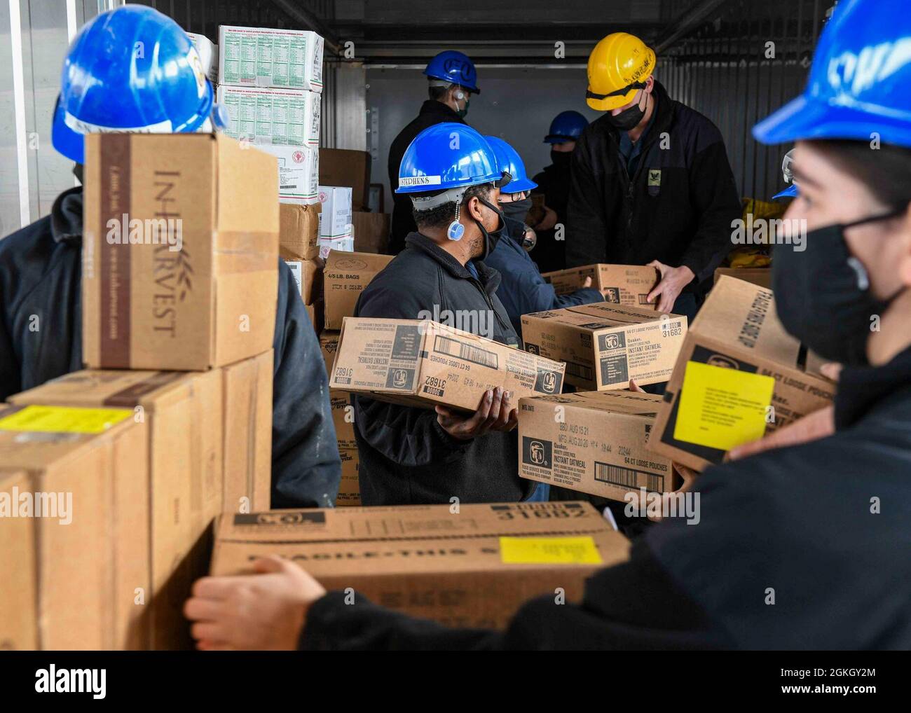 RIJEKA, Croatia (Apr. 19, 2021) Sailors place stores in a refrigerated storage unit aboard the Expeditionary Sea Base USS Hershel “Woody” Williams (ESB 4) in Rijeka, Croatia, Apr. 19, 2021. Hershel “Woody” Williams is on a scheduled deployment in the U.S. Sixth Fleet area of operations in support of U.S. national interests and security in Europe and Africa. Stock Photo