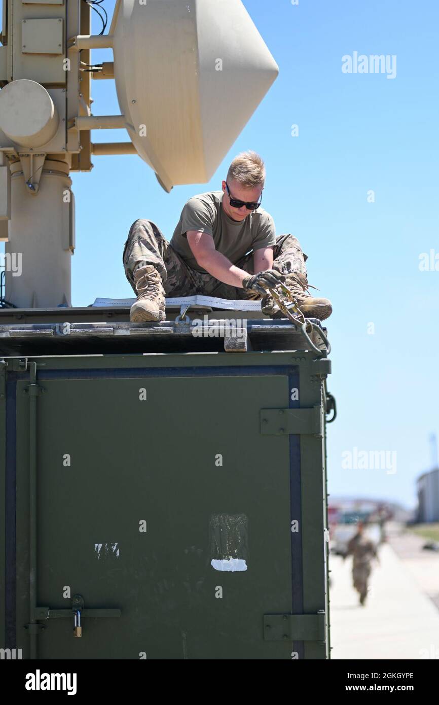 Senior Airman Brendan Hoffman, 727th Special Operations Aircraft Maintenance Squadron ground control station technician, secures a satellite on a shipping container, April 20, 2021, on Naval Air Station Point Mugu, California. Airmen and Guardians from the 49th Wing, Holloman Air Force Base, New Mexico; 452nd Air Mobility Wing, March Air Reserve Base, California; 27th Special Operations Wing, Cannon Air Force Base, New Mexico, and the 432nd Air Expeditionary Wing, Creech AFB, Nevada, joined to execute Exercise Agile Reaper. Stock Photo