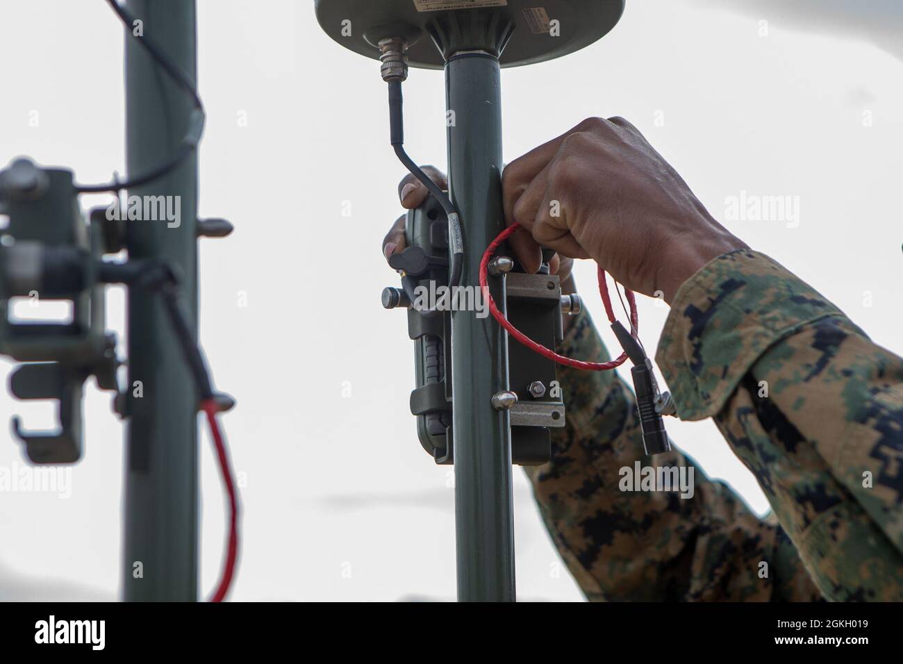 U.S. Marine Corps Lance Cpl. Lance Harris, a native of Phoenixville, Pa., and a field artillery sensor support with 3rd Battalion, 14th Marine Regiment, 4th Marine Division, set up a Defense Advanced GPS Receiver during Exercise Rolling Thunder 21.2 on Fort Bragg, N.C, April 19, 2021. This exercise is a 10th Marine Regiment-led live-fire artillery event that tests 10th Marines' abilities to operate in a simulated littoral environment against a peer threat in a dynamic and multi-domain scenario. Stock Photo