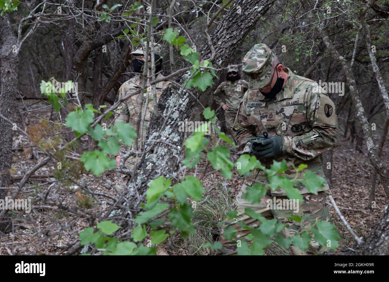 Soldier Using Compass U.S. Army Soldiers use compass to navigate through the woods during ...
