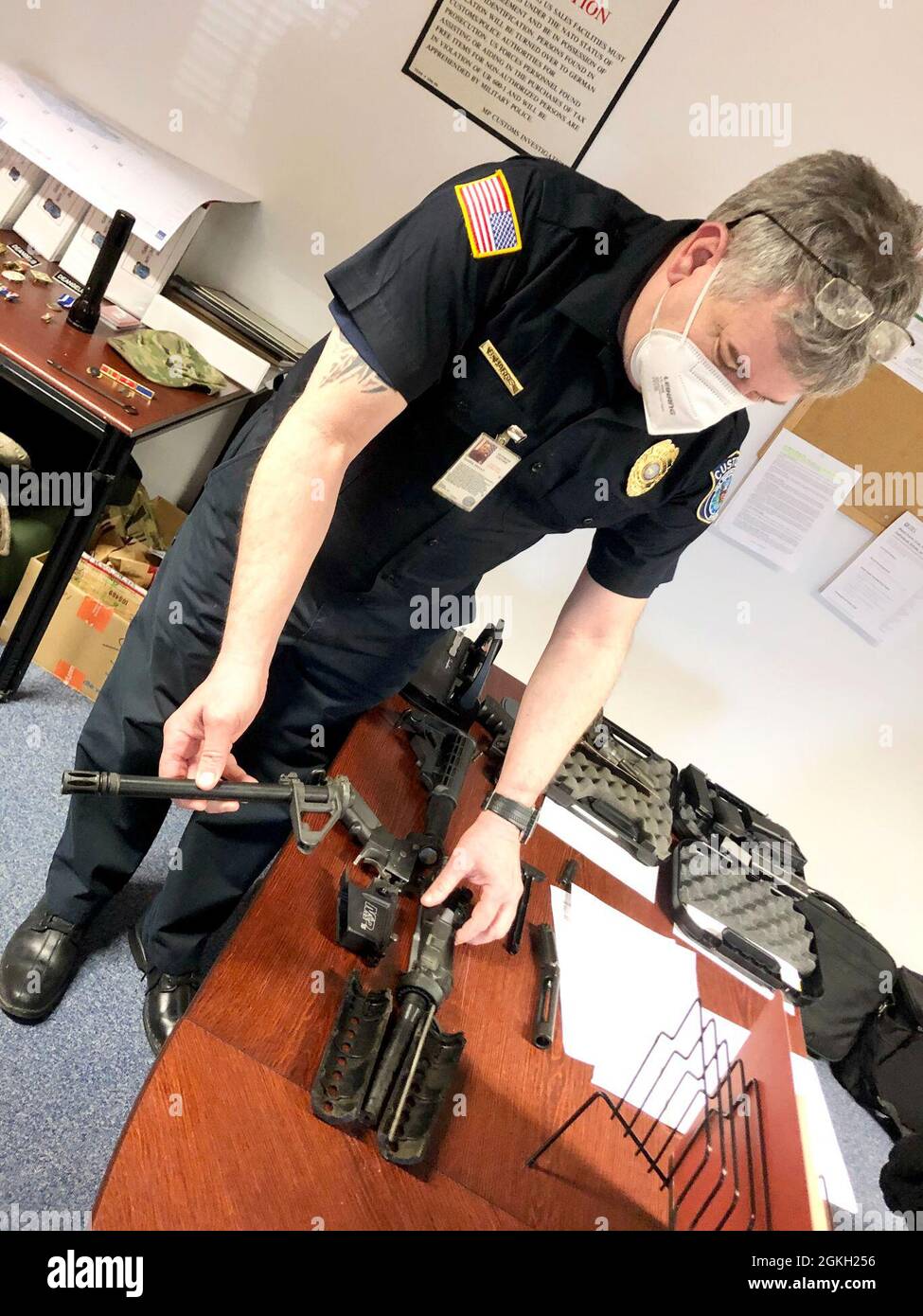 Customs Inspector Brian Harris, U.S. Army Europe-Africa Chief Customs Inspector in Rheinland-Pfalz, shows an AR-15 style rifle a Soldier shipped in their household goods. Customs inspectors had to destroy the rifle due to customs regulations. Stock Photo