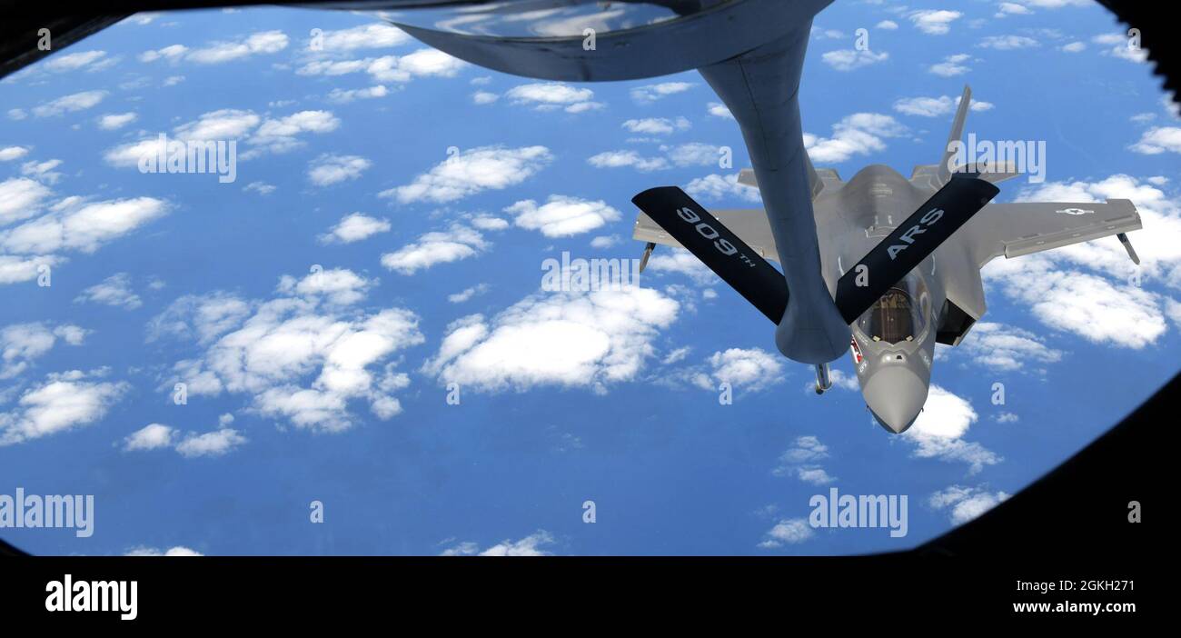 A U.S. Marine Corps F-35B Lightning II aircraft assigned to Marine Fighter Attack Squadron 121 from Marine Corps Air Station Iwakuni, Japan, conducts aerial refueling with a 909th Air Refueling Squadron KC-135 Stratotanker from Kadena Air Base, Japan, over the Pacific Ocean, Apr. 20, 2021. The Air Force and Marine Corps frequently conduct joint training operations in the Pacific to maintain high standards of proficiency and continue to demonstrate our commitment to the U.S-Japan Treaty of Mutual Security and Cooperation. Stock Photo