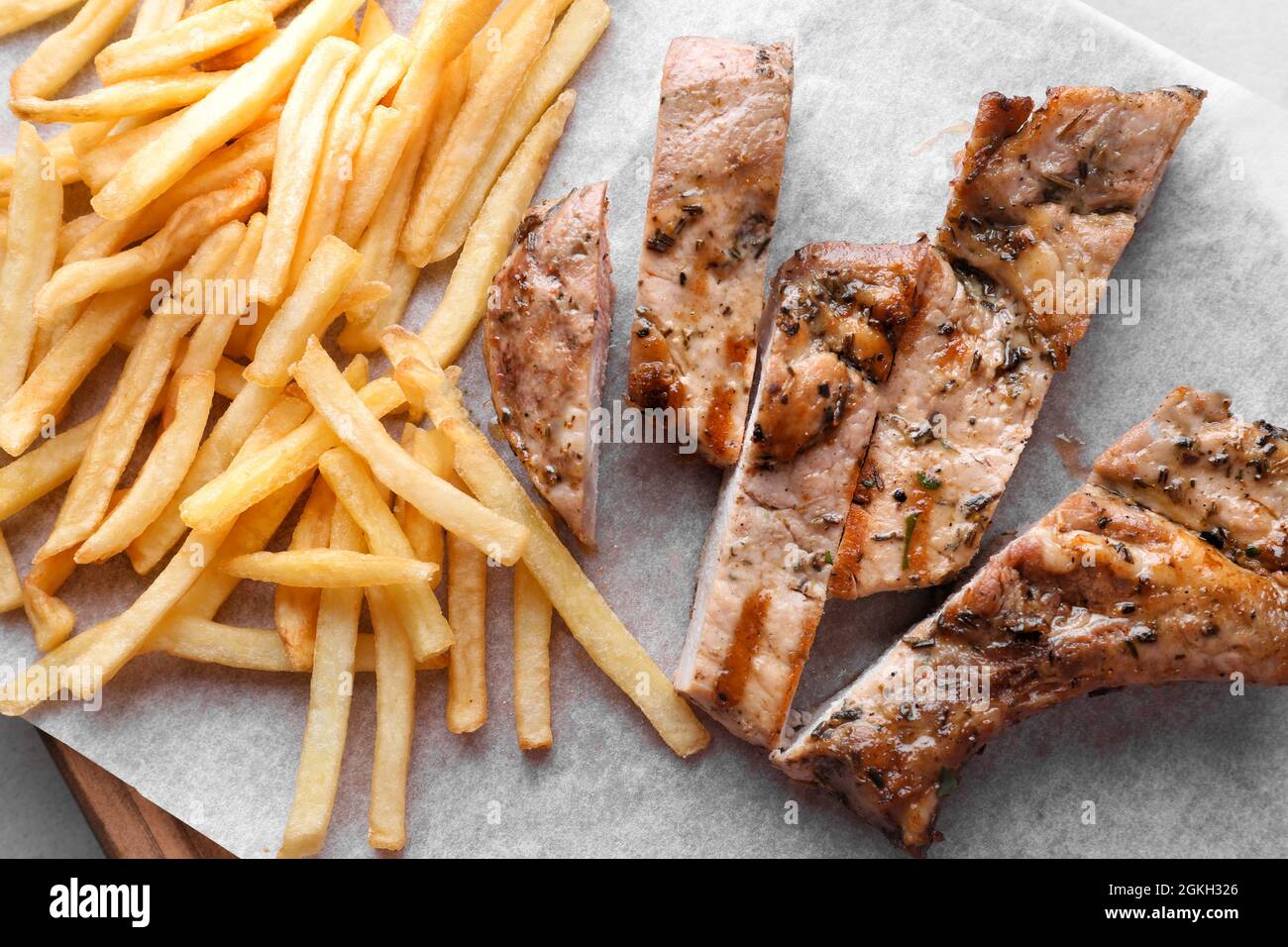Delicious grilled steak frites on waxed paper Stock Photo Alamy