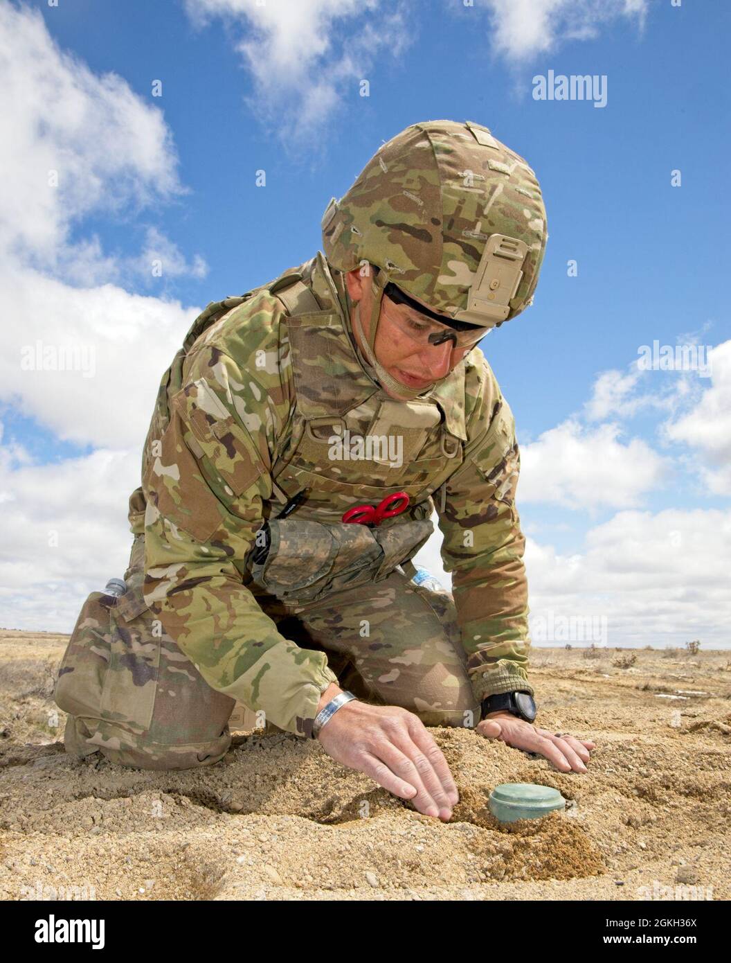 Staff Sgt. John Olivas, 79th EOD Bn., 704th EOD Co. delicately/gently uncovers a simulated mine during the 2021 EOD Team of the Year competition. The competition at Pinion Canyon Maneuver Site, Colorado included twelve of the best EOD teams, representing three battalions, 11 bases, and eight states. Stock Photo