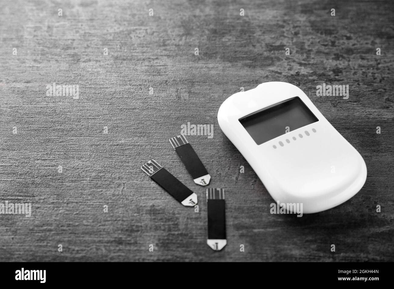 Digital glucose meter and test strips on table stock photo alamy