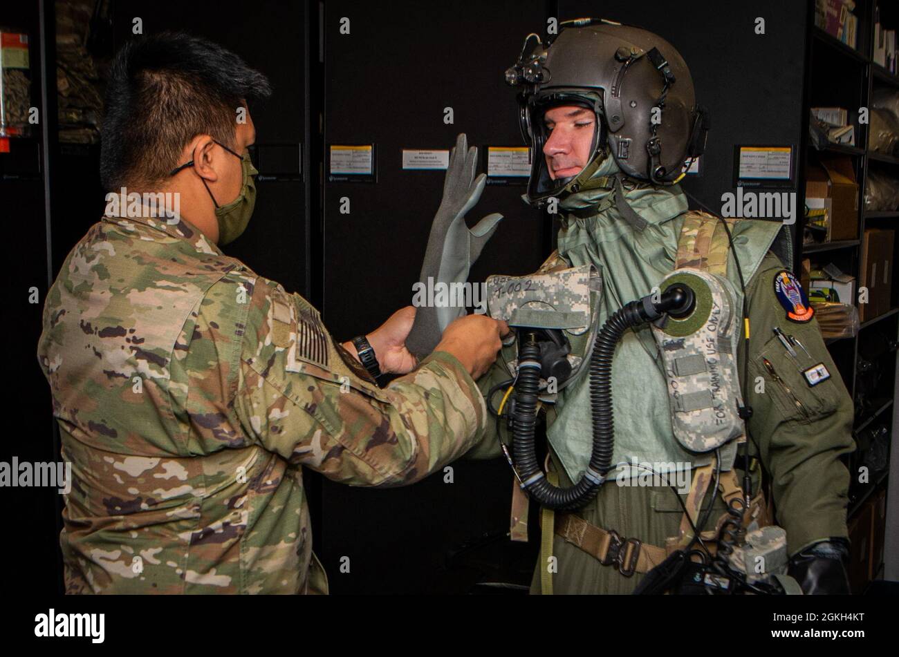 Maj. Daniel Morrissey, 88th Test and Evaluations Squadron (TES) assistant director of operations, is fitted with Chemical, Biological, Radiological, and Nuclear (CBRN) flight gear by Tech Sgt. Michael Engen, 88th TES aircrew flight equipment technician, before a development test at Nellis Air Force Base, Nevada, April 20, 2021. CBRN equipment provide Chemical, Biological, Radiological, and Nuclear protection to air crews in a toxic environment. Stock Photo