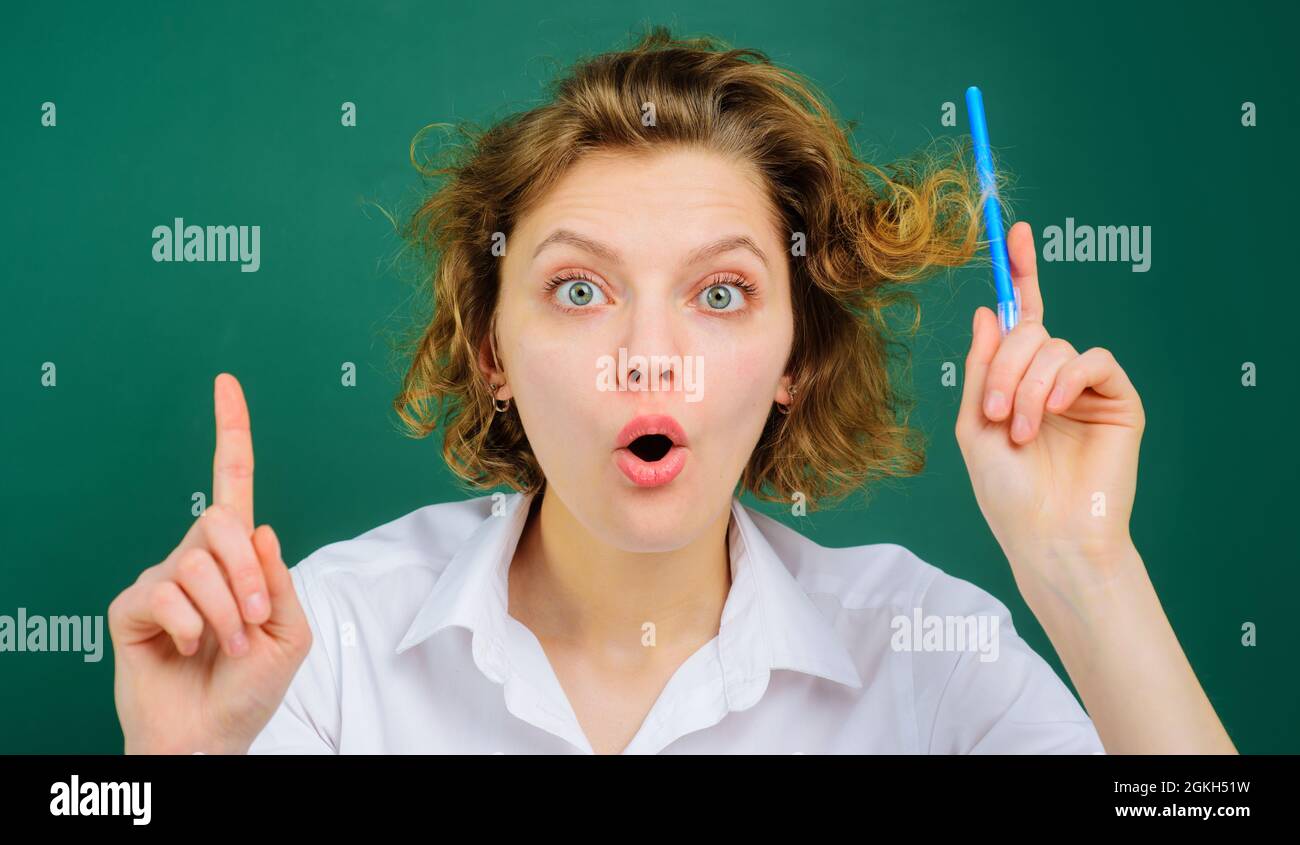 Female Teacher giving lesson to students in classroom. Back to school