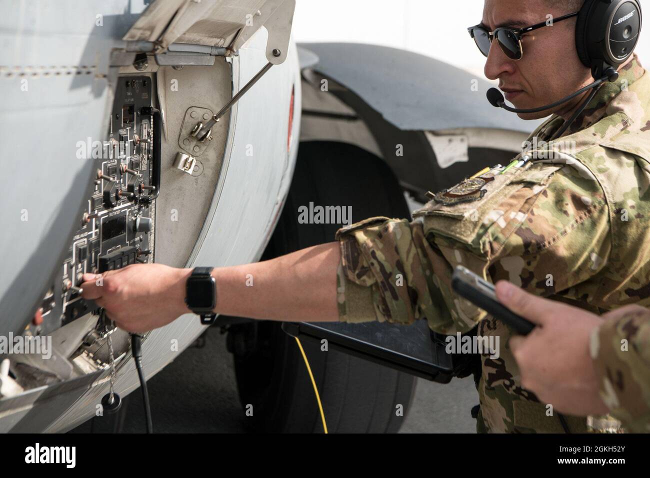 U.S. Air Force Staff Sgt. Roberto Barraza, loadmaster for the 816th Expeditionary Airlift Squadron, checks over a control panel for C-17 Globemaster III hot refueling operations during a training and certification mission at Al Udeid Air Base, Qatar, April 9, 2021. The 816th EAS and 379th Expeditionary Logistics Readiness Squadron Airmen performed multiple iterations of a process where the Aerial Bulk Fuel Delivery System was drained into an R-11 fuel truck, then the engines were left running for hot refueling from the truck to the aircraft, as well as a defueling process from the plane back t Stock Photo