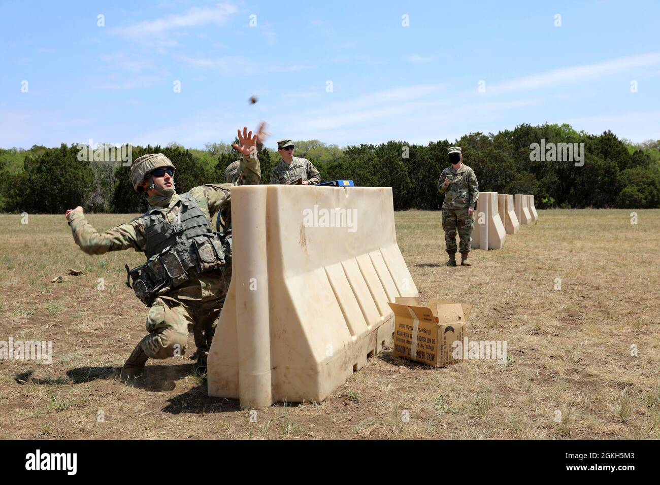 Spc. Karhl Wayman throws an inert grenade during the grenade toss event of the Military Intelligence Readiness Command (MIRC) Best Warrior Competition (BWC) at Joint Base San Antonio – Camp Bullis April 21, 2021. Events such as the grenade toss test the competitors’ capabilities and combat-readiness and help determine which Soldier will be named the MIRC’s Best Warrior. Stock Photo