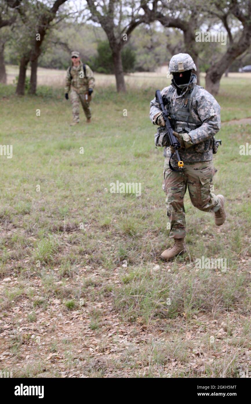 Sgt. Joshua Miller, 368th Military Intelligence Battalion, bounds forward during the Military Intelligence Readiness Command (MIRC) Best Squad Competition (BSC) April 21, 2021, at Joint Base San Antonio – Camp Bullis. Events such as the obstacle course test the competitors’ capabilities and combat-readiness and help determine which Soldier will be named the MIRC’s Best Warrior. Stock Photo