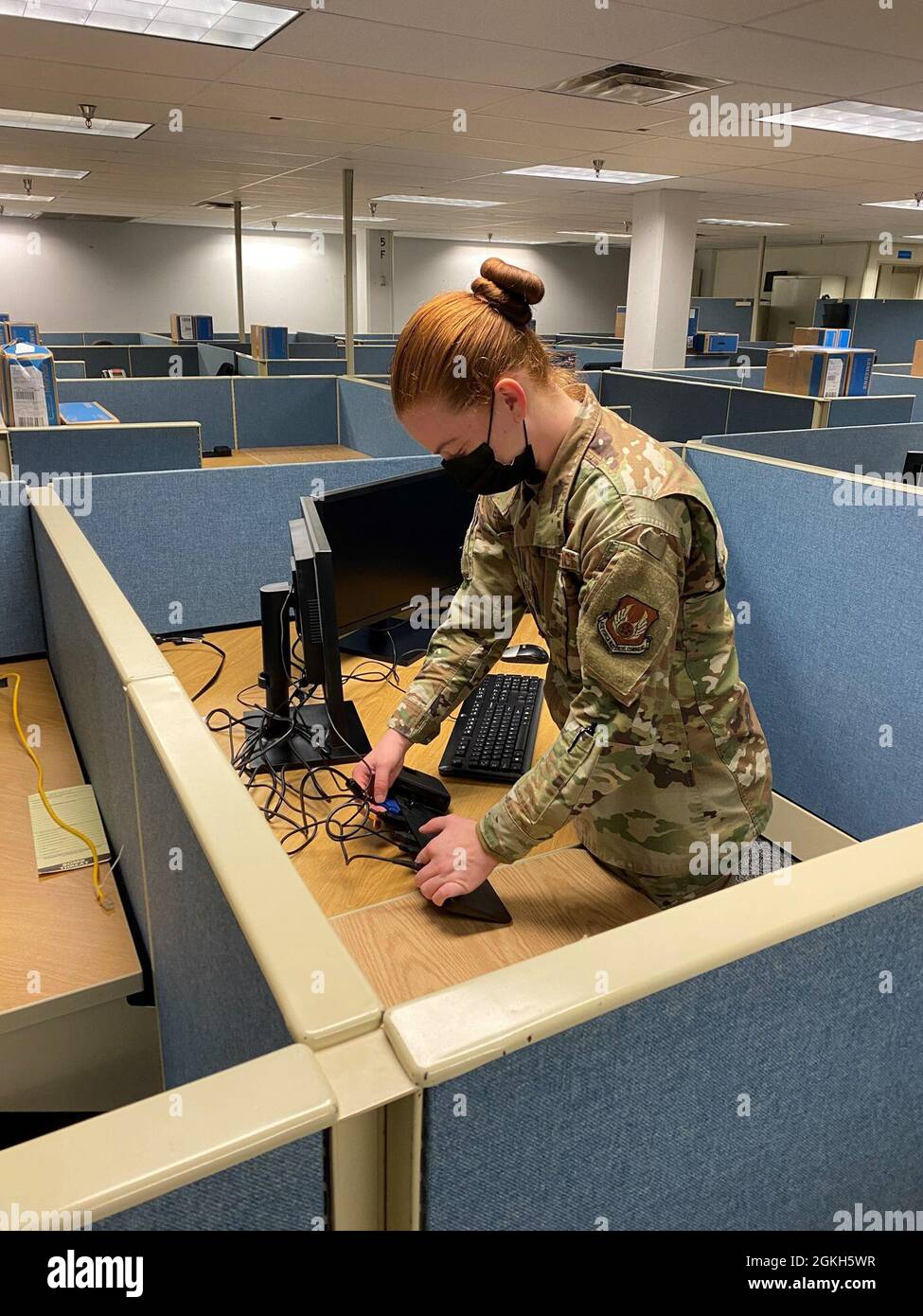 Staff Sgt. Elda Quesenberry connects a new computer work station in preparation for the transitional wave of office moves required by the future renovation of Headquarters AFMC, Bldg. 262/266. Stock Photo
