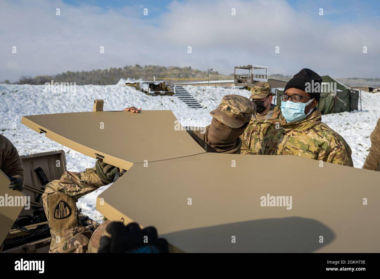 U.S. Army Soldiers assigned to B Co. 101st Expeditionary Signal Battalion, 369th Sustainment Brigade, 53rd Troop Command, prepare a portable satellite transmission terminal, known as SNAP, at Regional Support Camp Nighthawk, Nineveh, Ind., April 21, 2021. SNAP is a SIPR NIPR Access Point. NY National Guard Soldiers provide operational and logistical support to other state National Guard battalions during the Guardian Response Exercise 21 Indiana. Stock Photo