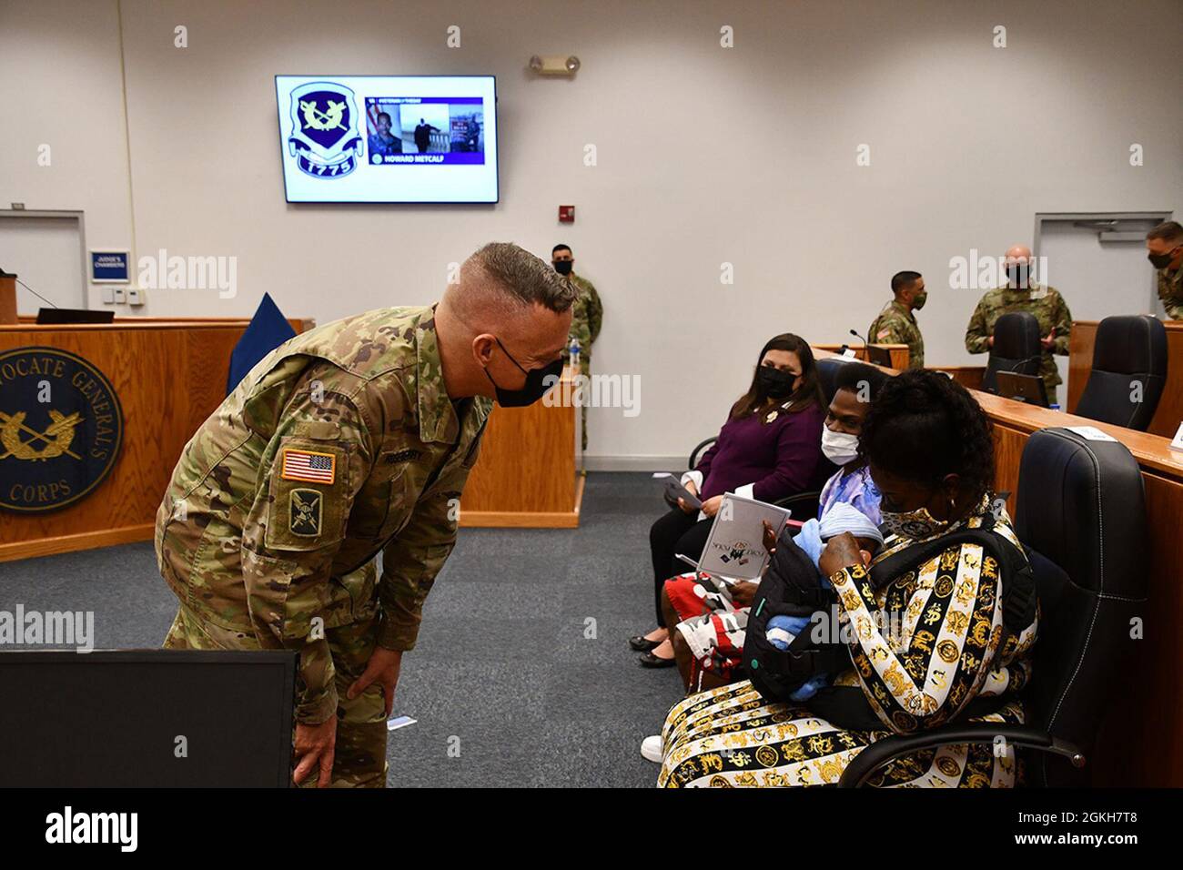 Col. Ryan K. Roseberry, Fort Polk garrison commander, admires a sleeping Khalil Metcalf, 3 months old, before the ceremony honoring his grandfather, Sgt. Maj. Howard Metcalf, April 21. Stock Photo