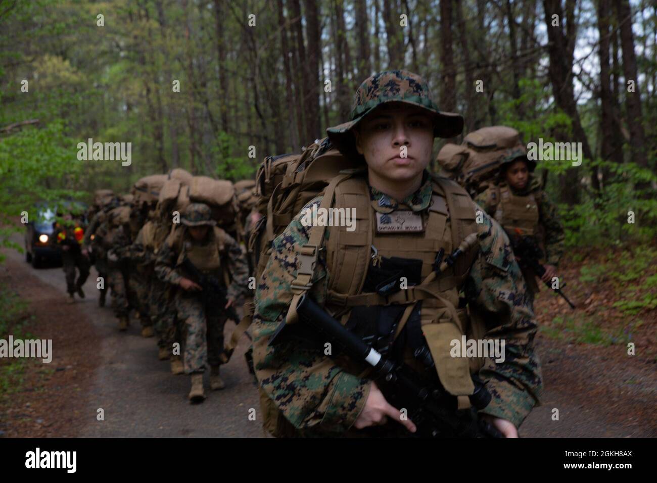 U.S. Marine Corps Sergeant Maria Santiago, a motor vehicle operator and training chief with Headquarters and Service Battalion, U.S. Marine Corps Forces Command, leads a hike to landing zone Thrush at Quantico, Virginia, April 21, 2021. During the field training exercise, Marines conducted land navigation and close, long and unknown distance shooting while building squad level operational cohesion. Stock Photo