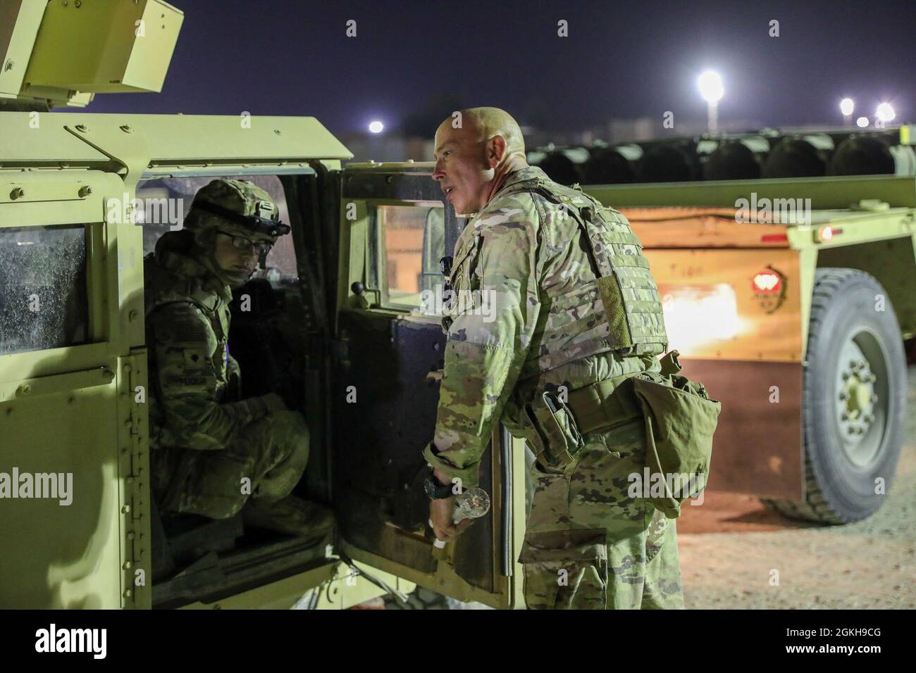 U.S. Army Sgt. 1st Class Truxton Ryan, right, platoon Sgt., Delta Company 3-172 Infantry-Mountain, Task Force Iron Valor, checks staged vehicles in Kuwait, April 21, 2021. Ryan talks with a soldier from TF Iron Valor participating in a timed validation exercise. Stock Photo