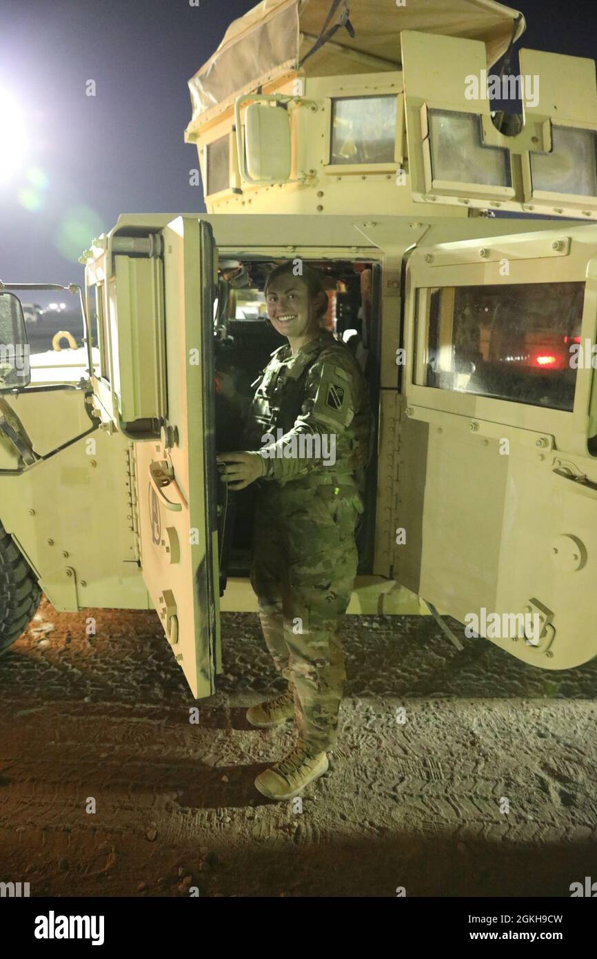 U.S. Army Spc. Kassidy Mayfield, driver, 2nd platoon, Bravo Company, 1-181 Field Artillery Regiment, Task Force Iron Valor, posed with her assigned vehicle in Kuwait, April 21, 2021. Mayfield took part in a timed validation exercise to train and prepare for a rapid response. Stock Photo