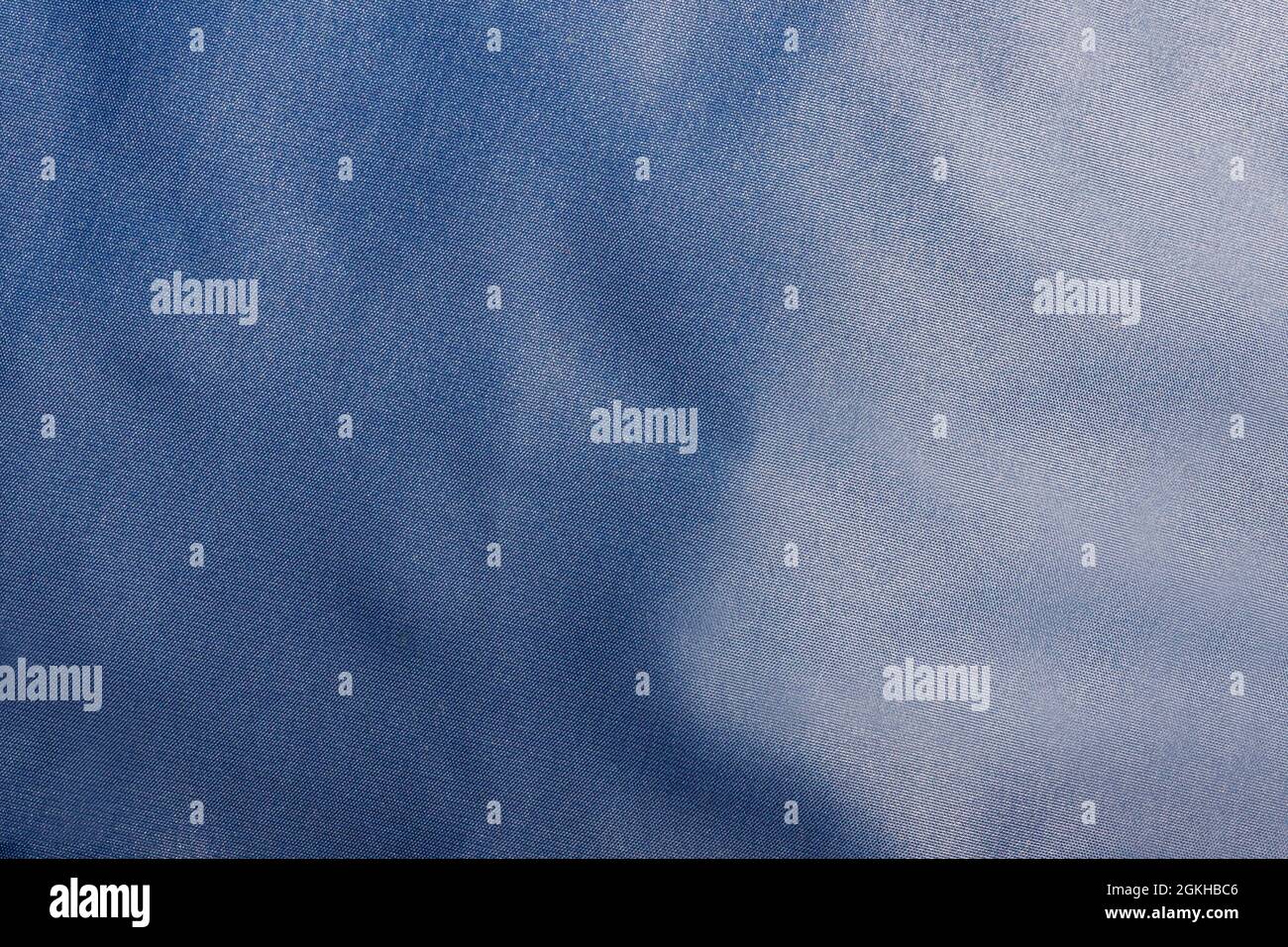 Texture backdrop photo of blue colored and folded bologna fabric Stock