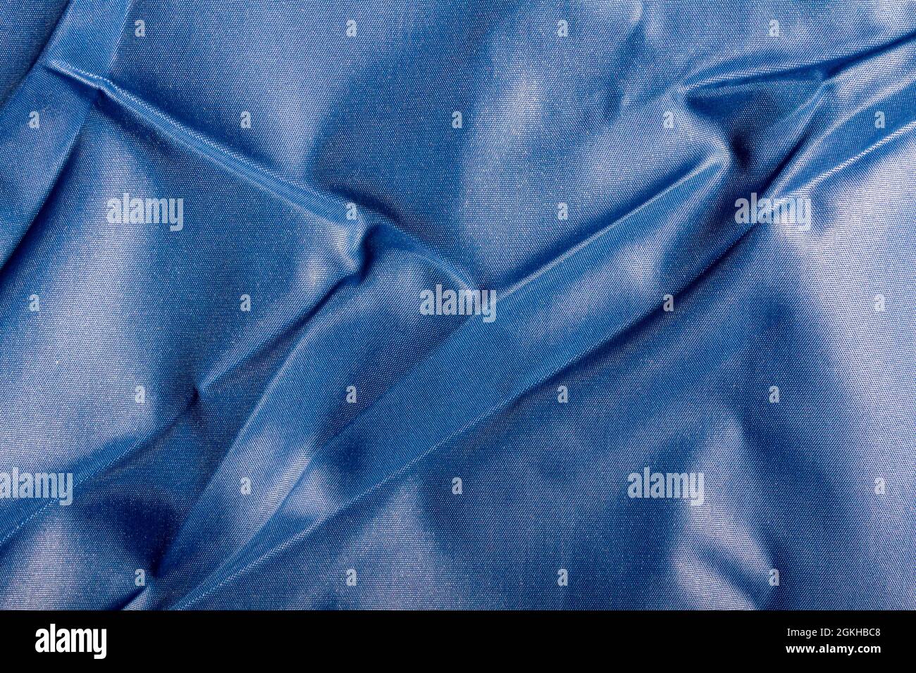 Texture backdrop photo of blue colored and folded bologna fabric Stock