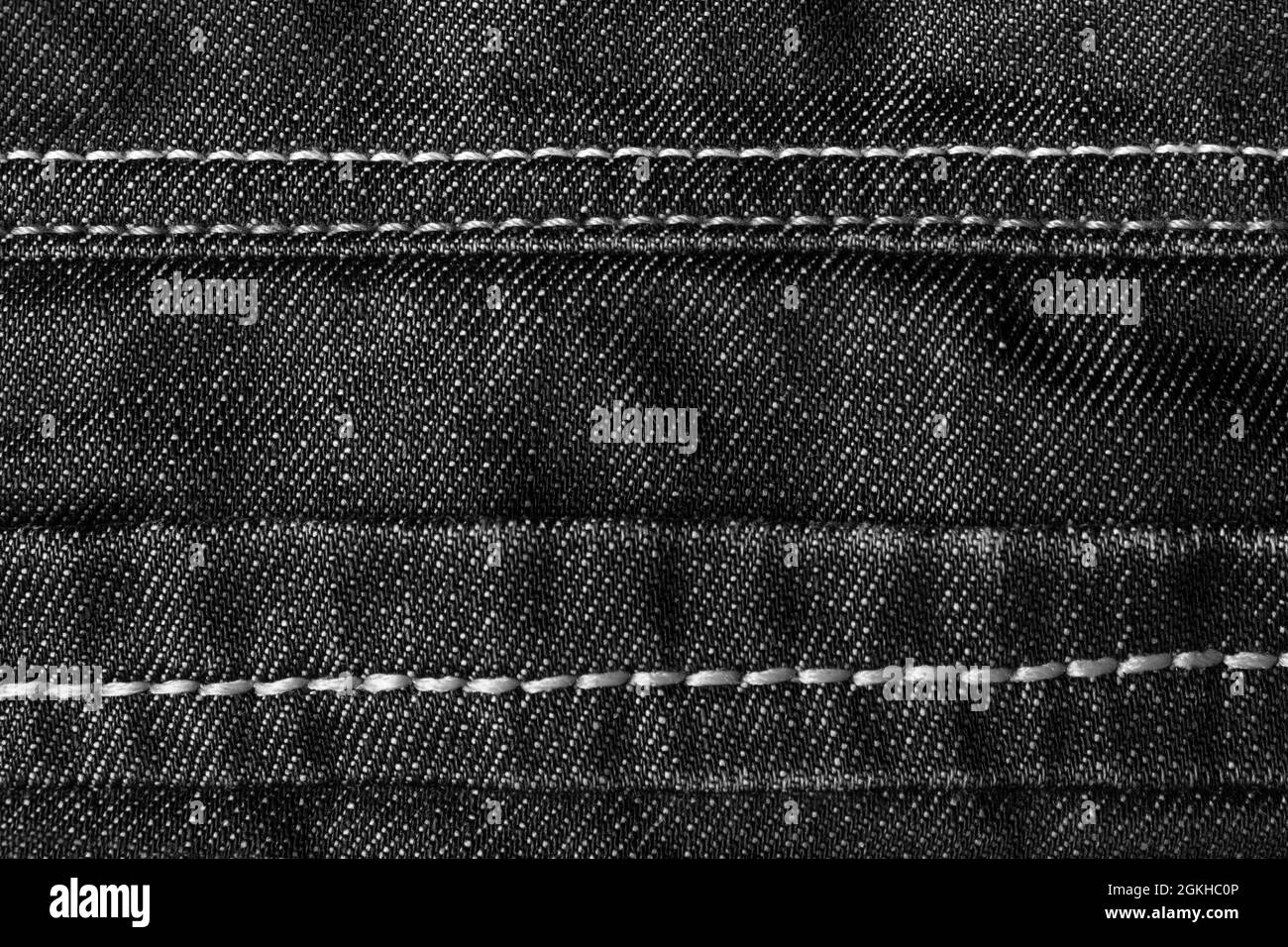 Texture backdrop photo of denim jeans cloth with seams and folds. Stock Photo