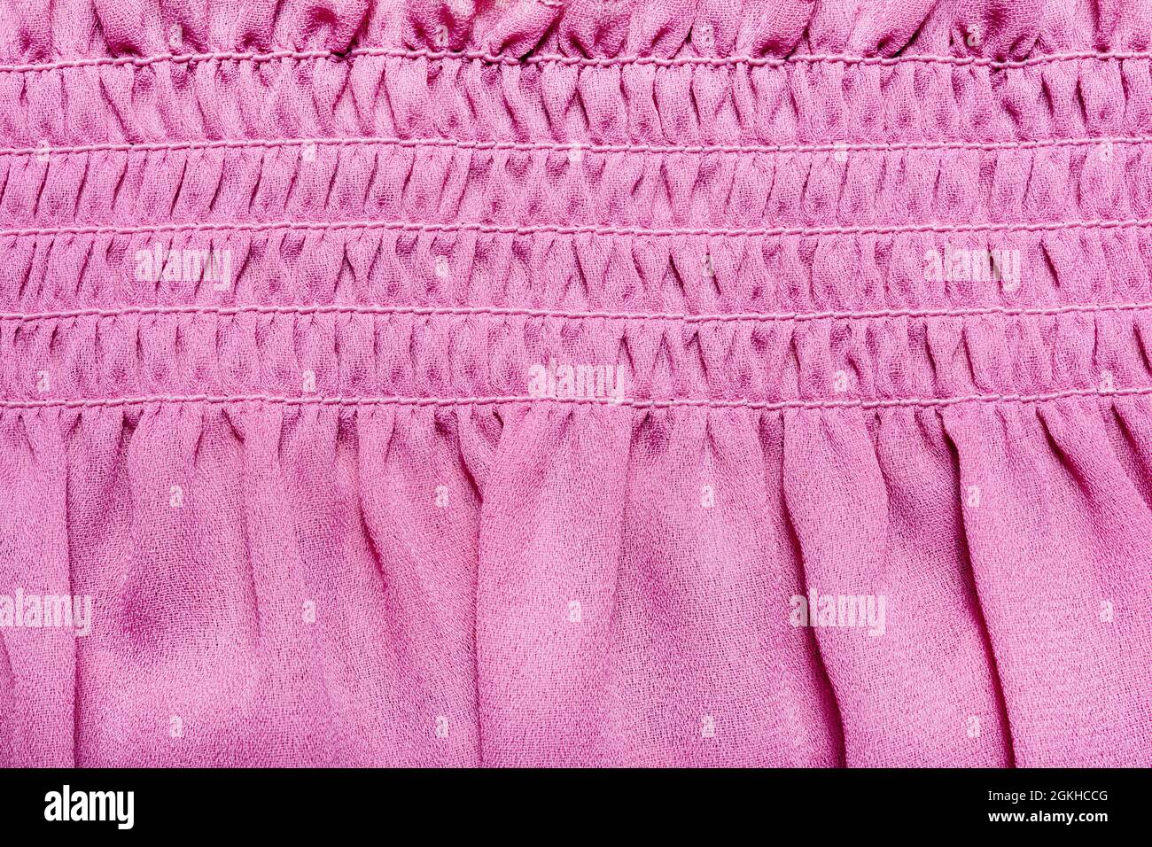 Texture backdrop photo of pink colored frill dress cloth fabric. Stock Photo