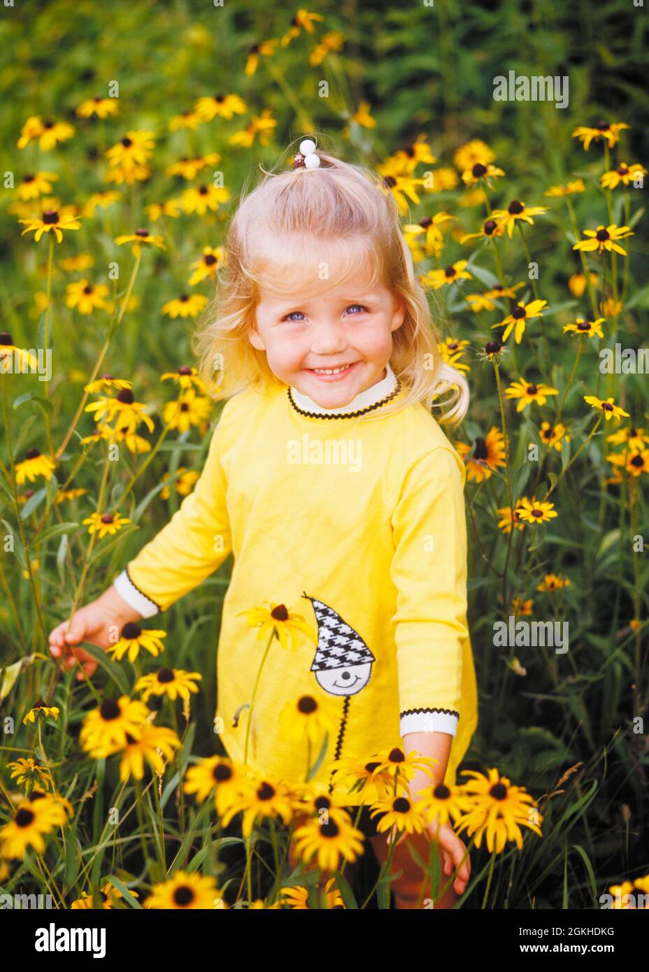 1970s SMILING BLONDE GIRL WEARING YELLOW DRESS STANDING IN FIELD OF BLACK-EYED SUSAN YELLOW DAISIES LOOKING AY CAMERA - kj4845 HAR001 HARS HEALTHINESS NATURE COPY SPACE HALF-LENGTH INSPIRATION SERENITY SPIRITUALITY CONFIDENCE EYE CONTACT DAISIES HAPPINESS WELLNESS HEAD AND SHOULDERS CHEERFUL HIGH ANGLE ADVENTURE DISCOVERY ENVIRONMENT EXCITEMENT OPPORTUNITY SMILES BLACK-EYED CONNECTION SUSAN CONCEPTUAL JOYFUL CHARMING GROWTH JUVENILES CAUCASIAN ETHNICITY EXPLORING HAR001 INNOCENT OLD FASHIONED Stock Photo