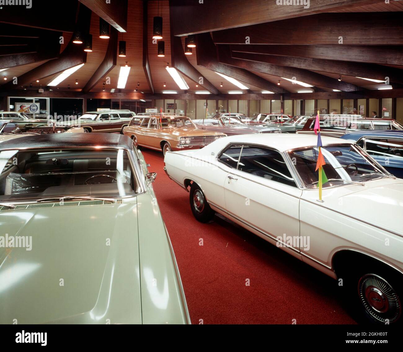 1970s 1975 AUTOMOBILE DEALER SALES SHOWROOM NEW CAR MODELS SEDANS STATION WAGON CENTER PIECE OTHERS IN A SURROUNDING CIRCLE - km3494 PEA001 HARS MOTOR VEHICLE AUTOS CHOICE EXCITEMENT PRIDE OPPORTUNITY MOTORING OCCUPATIONS CONCEPTUAL AUTOMOBILES MOBILITY STYLISH VEHICLES COMMERCE OLD FASHIONED Stock Photo