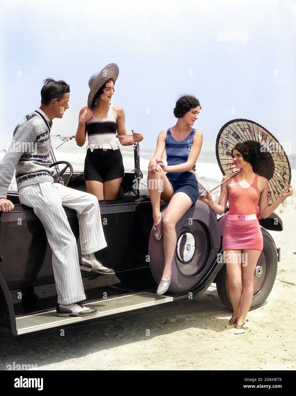 1920s MAN AND THREE WOMEN IN BEACH CLOTHES OR BATHING SUITS POSING AROUND CAR ON RUNNING BOARD AT SEASHORE - m2785c HAR001 HARS COLOR SOCIAL OLD TIME NOSTALGIA RUNNER GOOD OLD FASHION AUTO SISTER 1 FITNESS STYLE MOTOR BATHING VEHICLE YOUNG ADULT SUITS VACATION WEST FIT LIFESTYLE OCEAN FEMALES RURAL GROWNUP TRANSPORT COPY SPACE FULL-LENGTH LADIES PERSONS GROWN-UP AUTOMOBILE MALES SIBLINGS SISTERS TRANSPORTATION TIME OFF STYLES MOTOR VEHICLE PARASOL TRIP AUTOS GETAWAY TRIO HOLIDAYS MOTORING POSING SIBLING SWIM SUIT UPSCALE WEST COAST GOOD HEALTH AUTOMOBILES PACKARD TOURING CAR SANDY STYLISH Stock Photo
