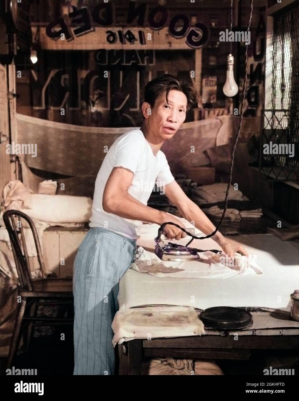 1920s CHINESE LAUNDRY MAN LOOKING AT CAMERA WORKING HARD IRONING 