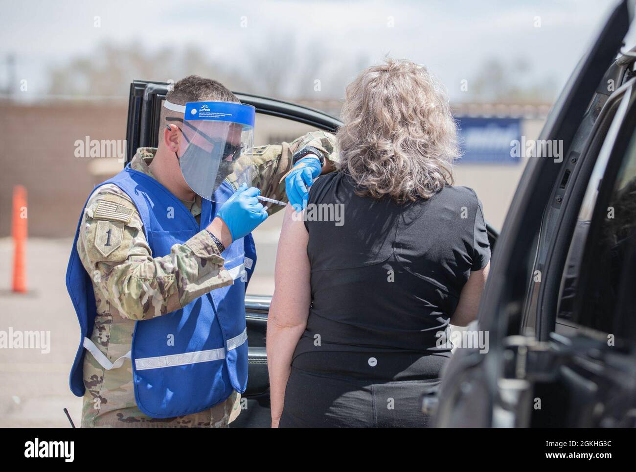 U.S. Army Sgt. Alec Derr, a combat medic assigned to 2nd Stryker Brigade Combat Team, 4th Infantry Division, administers a vaccination to a community member in Pueblo, Colorado, April 23, 2021. The Soldiers deployed from Fort Carson, Colorado, to provide support at the Pueblo Community Vaccination Center. U.S. Northern Command, through U.S. Army North, remains committed to providing continued, flexible Department of Defense support to the Federal Emergency Management Agency as part of the whole-of-government response to COVID-19. Stock Photo