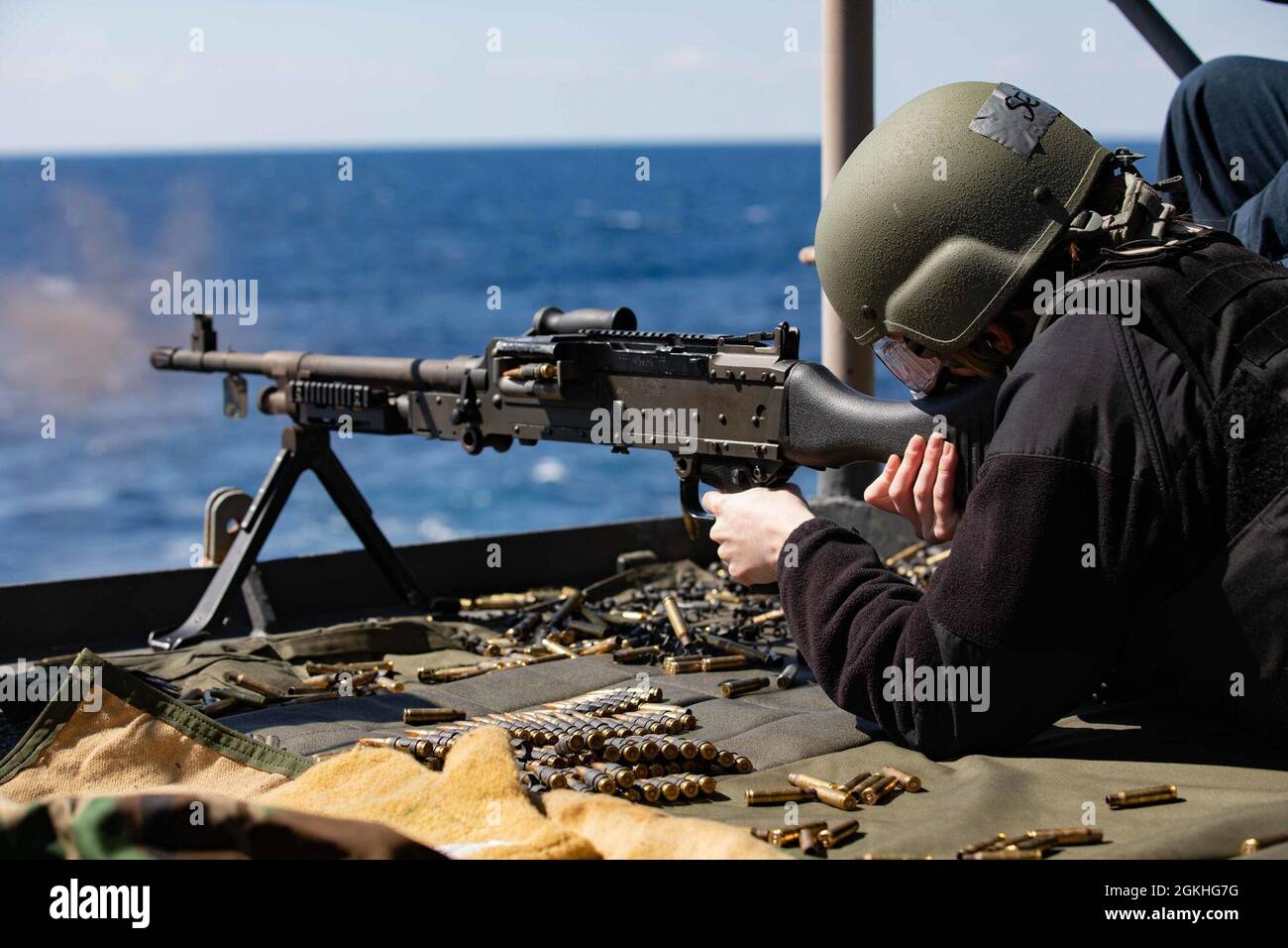 210423-N-VM474-1183 ATLANTIC OCEAN (April 23, 2021) Yeoman 3rd Class Hannah Smith fires an M240B machine gun during a live-fire qualification event aboard the Wasp-class amphibious assault ship USS Kearsarge (LHD 3) April 23, 2021. Kearsarge, homeported at Naval Station Norfolk, is underway to certify for operations at sea. Stock Photo