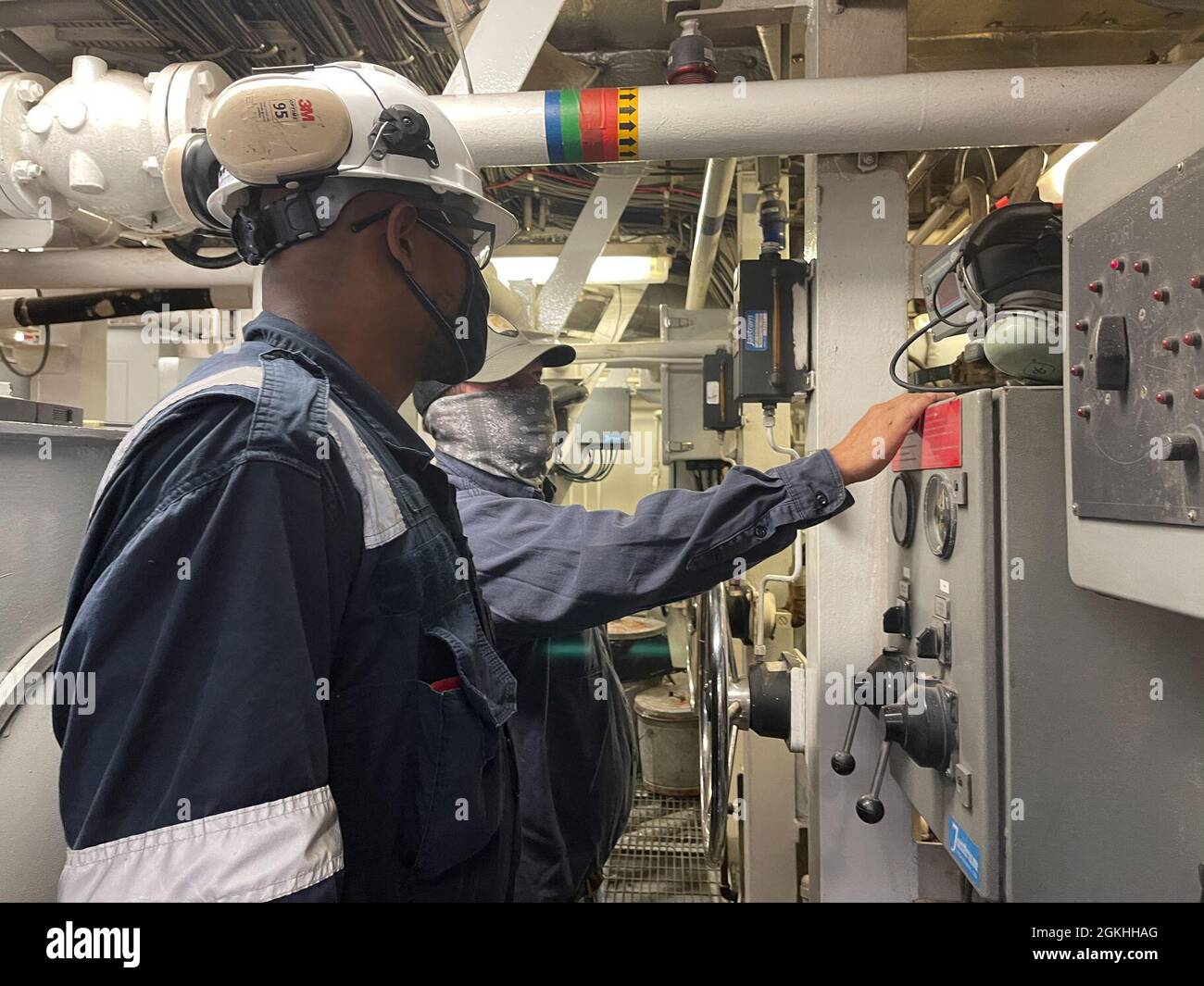 Coast Guard Marine Inspector Adrian Hill and a SEACOR Eagle crew member inspect the engine room onboard the SEACOR Eagle in Houma, Louisiana, April 23, 2021. The crew and vessel was inspected by Coast Guard marine inspectors for readiness and approval to be used as an asset for the SEACOR Power response. Stock Photo